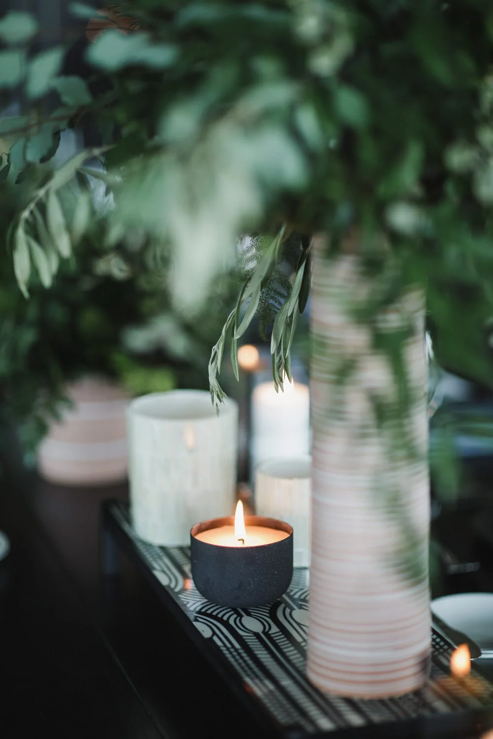wedding reception tablescapes with black and white design and all green florals black votive candle holder
