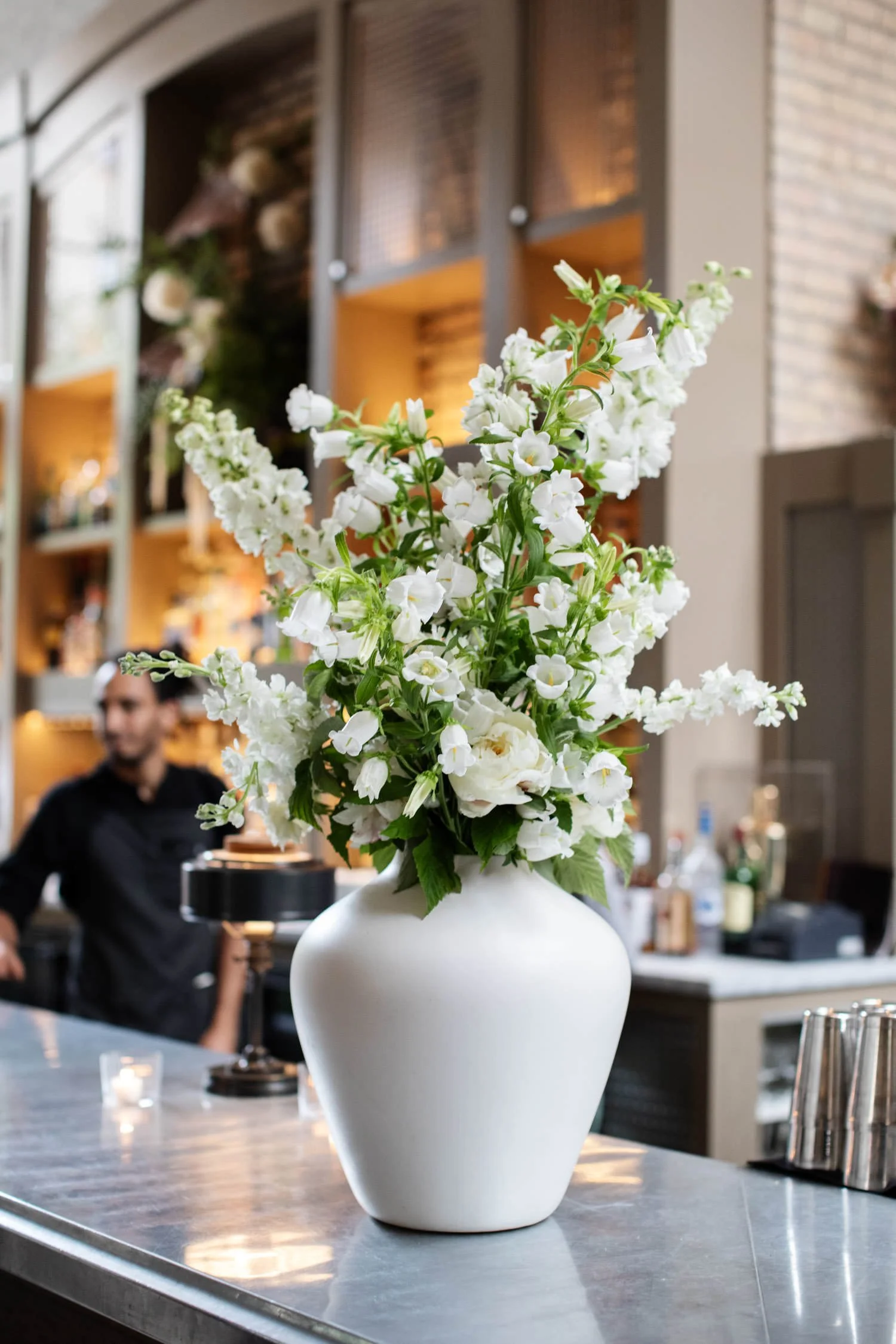 White cut floral bouquet in large white vase. Minneapolis rehearsal dinner, Spoon and Stable restaurant, Designed by Rocket Science Events.