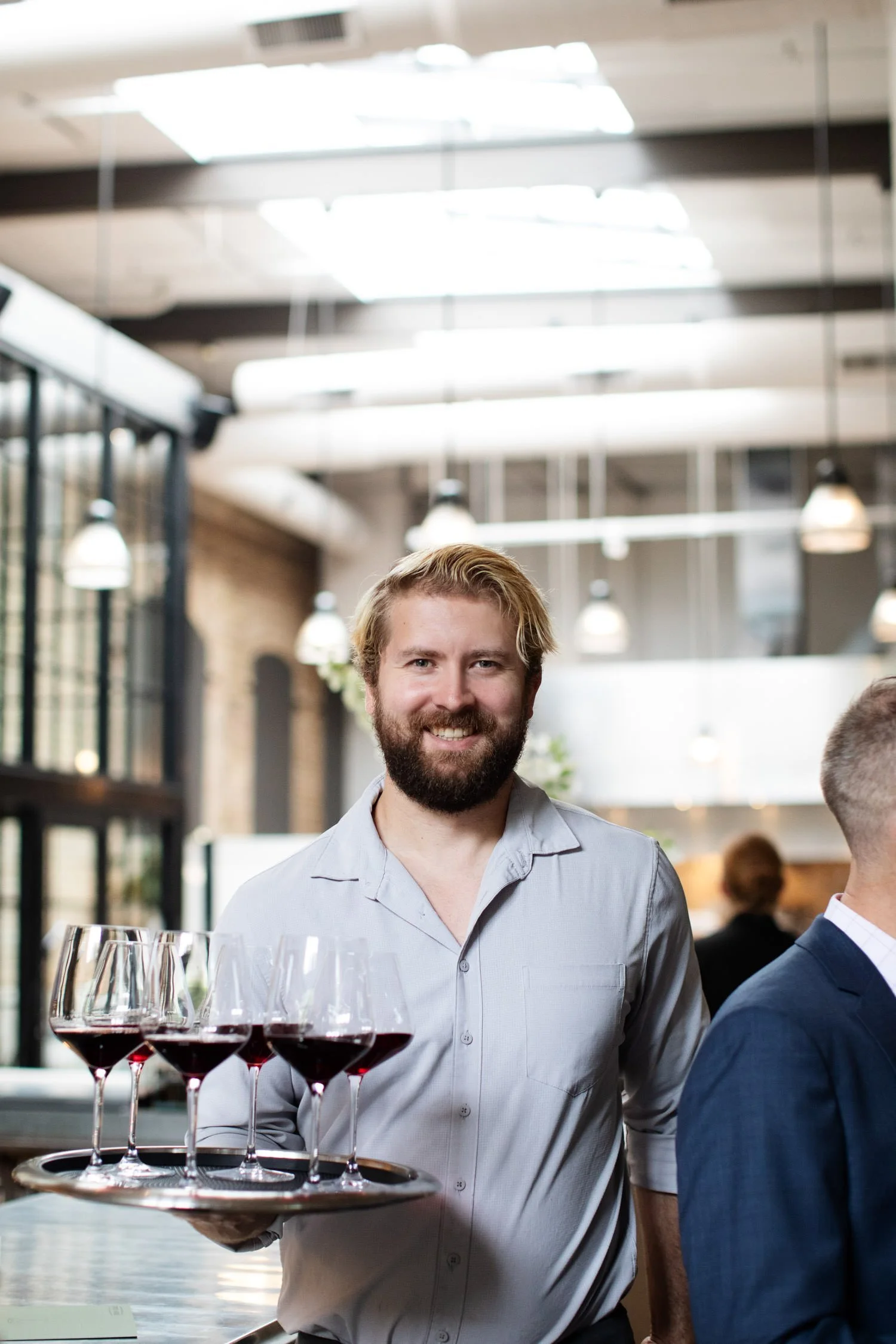 Waitstaff at rehearsal dinner sharing glasses of red wine with guests. Minneapolis rehearsal dinner, Spoon and Stable restaurant, Planned by Rocket Science Events.
