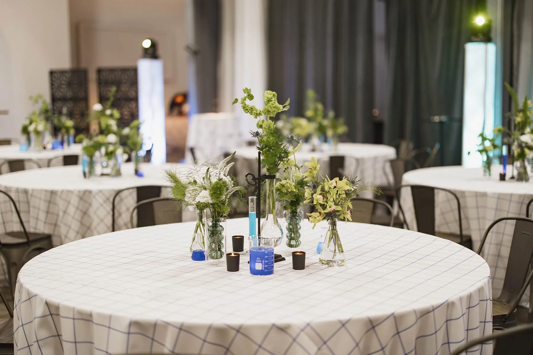 Rounds reception tables with science themed centerpieces at a Minneapolis Bar Mitzvah planned by Rocket Science Events