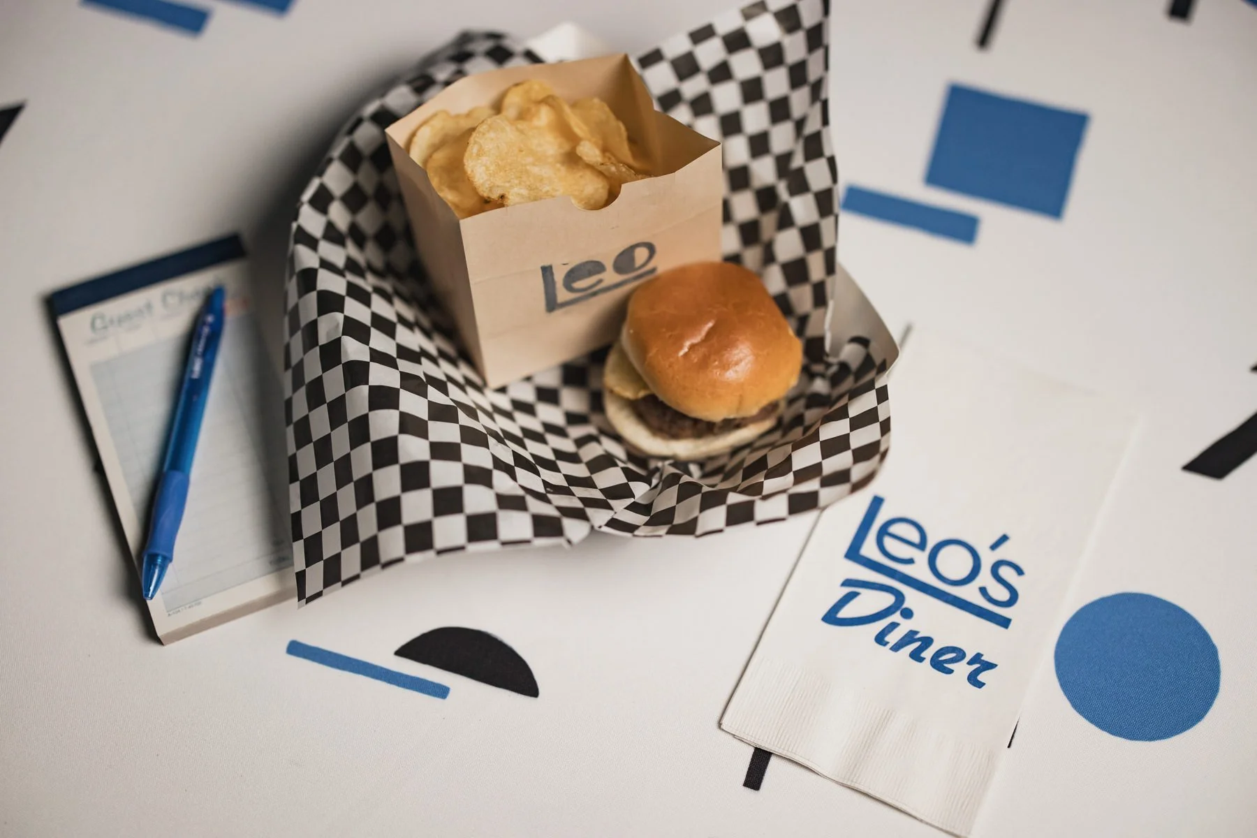 A burger, chips and napkin with personalized diner logo at a Minneapolis Bar Mitzvah planned by Rocket Science Events