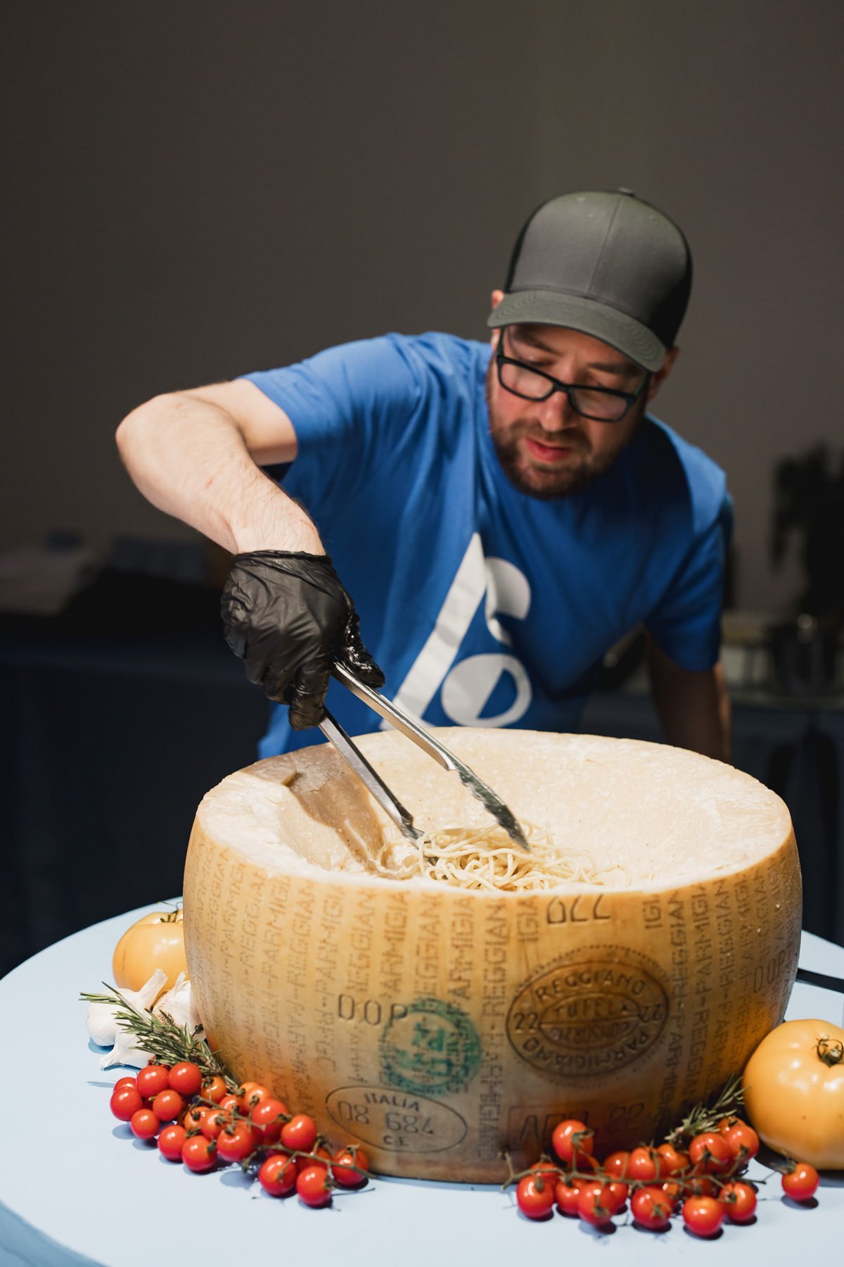 Cacio e Pepe being made in a giant wheel of parmesan at a Minneapolis Bar Mitzvah planned by Rocket Science Events