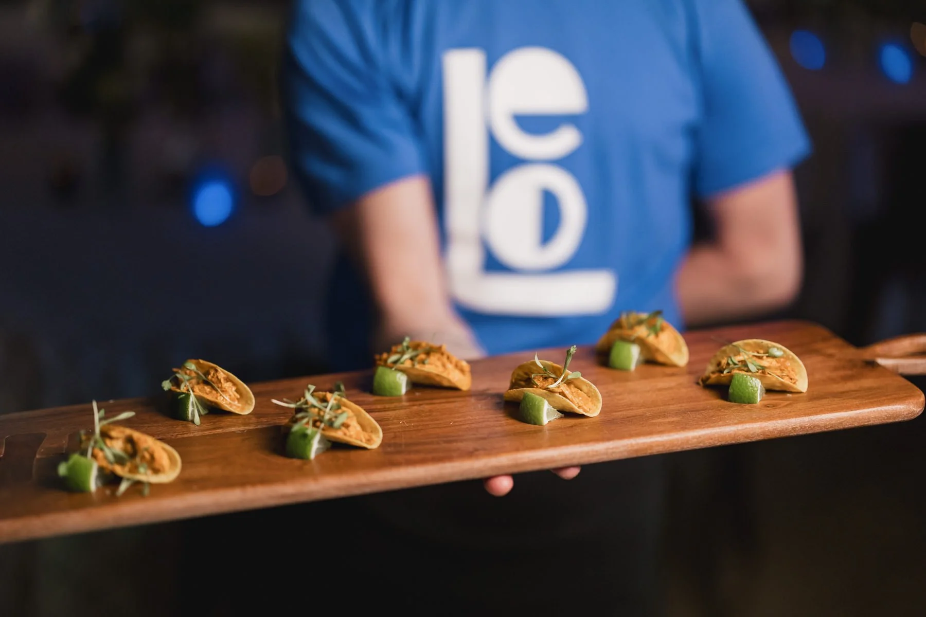 A server holding a tray of mini tacos at a Minneapolis Bar Mitzvah planned by Rocket Science Events