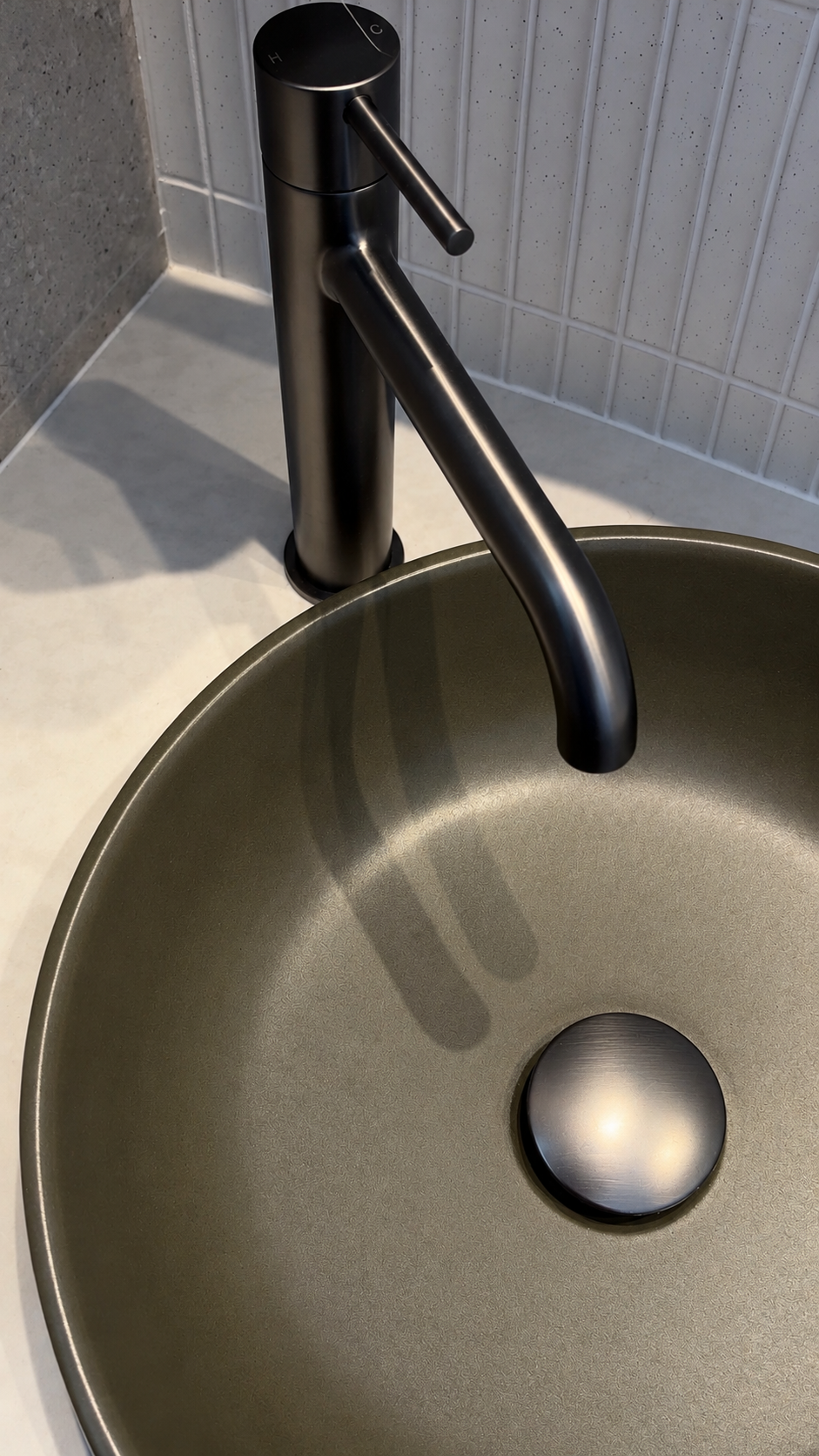 Matte black tapware and stone vessel basin