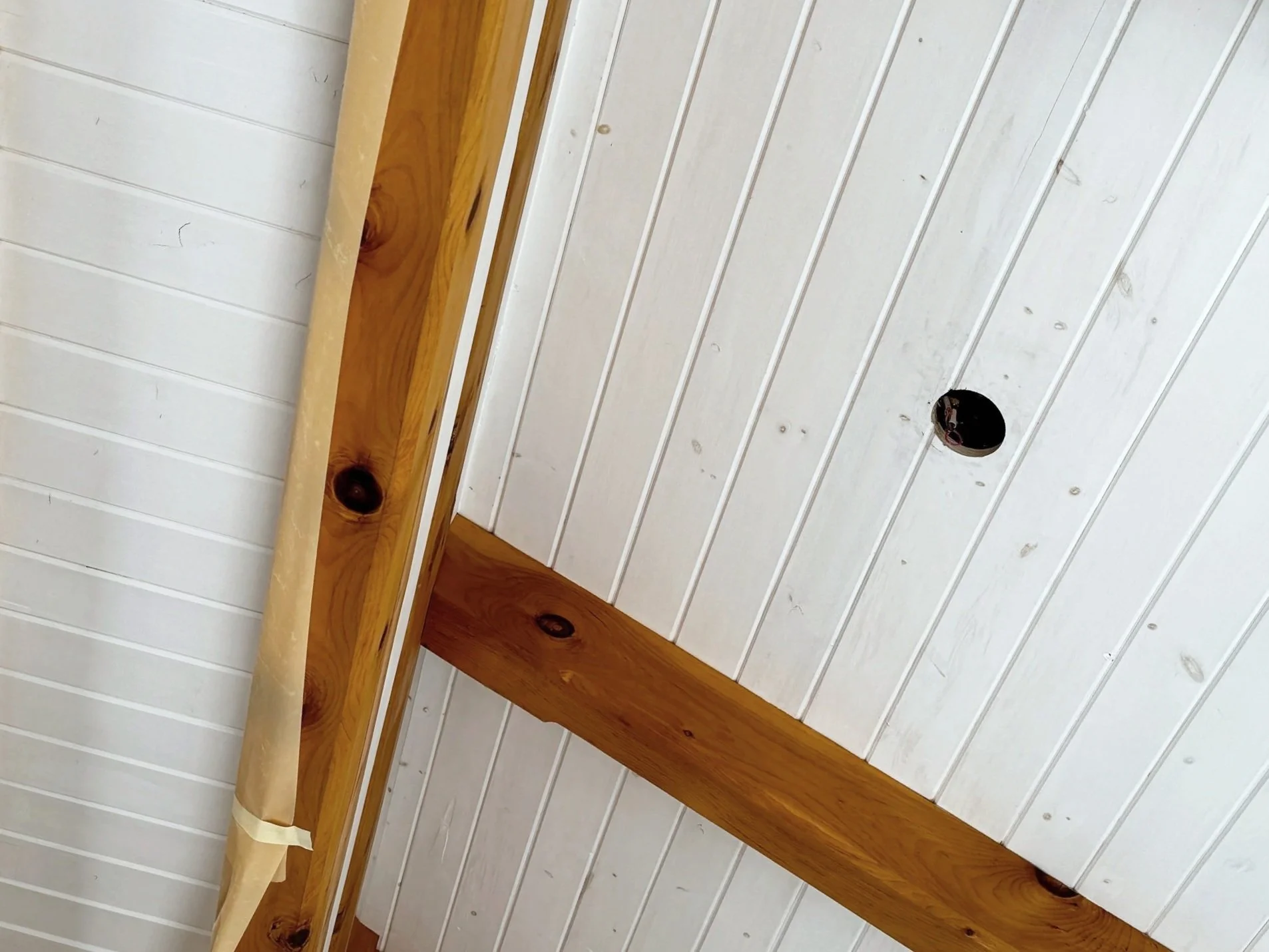Tongue-and-groove ceiling restoration — sanded, refinished, and sealed to bring back warmth and uniformity. Before and after