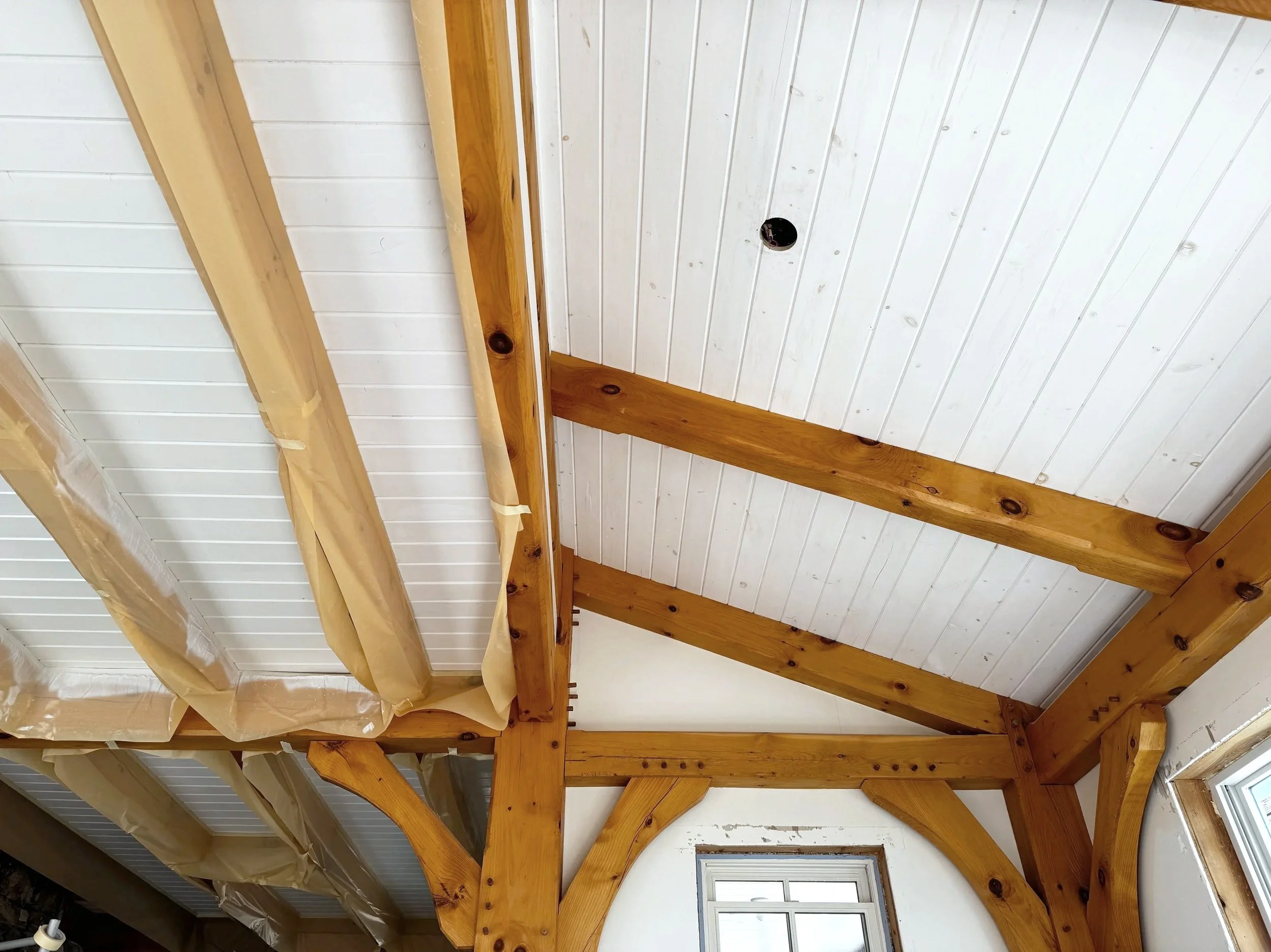 Tongue-and-groove ceiling restoration — sanded, refinished, and sealed to bring back warmth and uniformity.