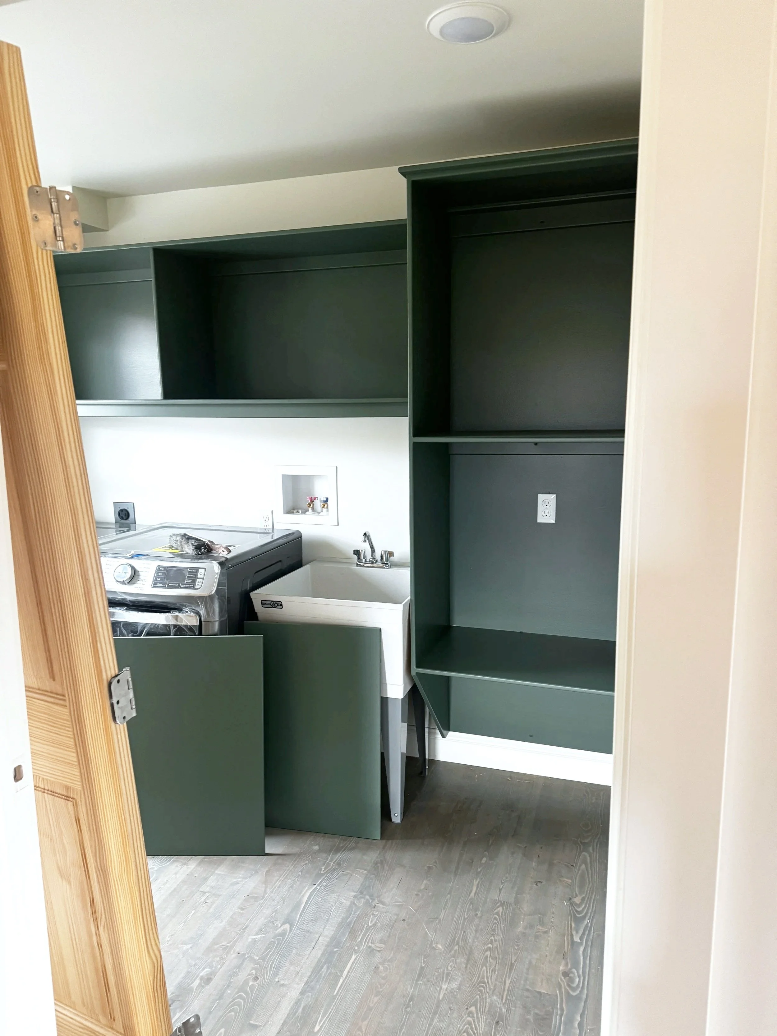 Factory-finish sprayed built-in cabinetry in a laundry room—finished in place by Monarch Paint Design, Missoula.