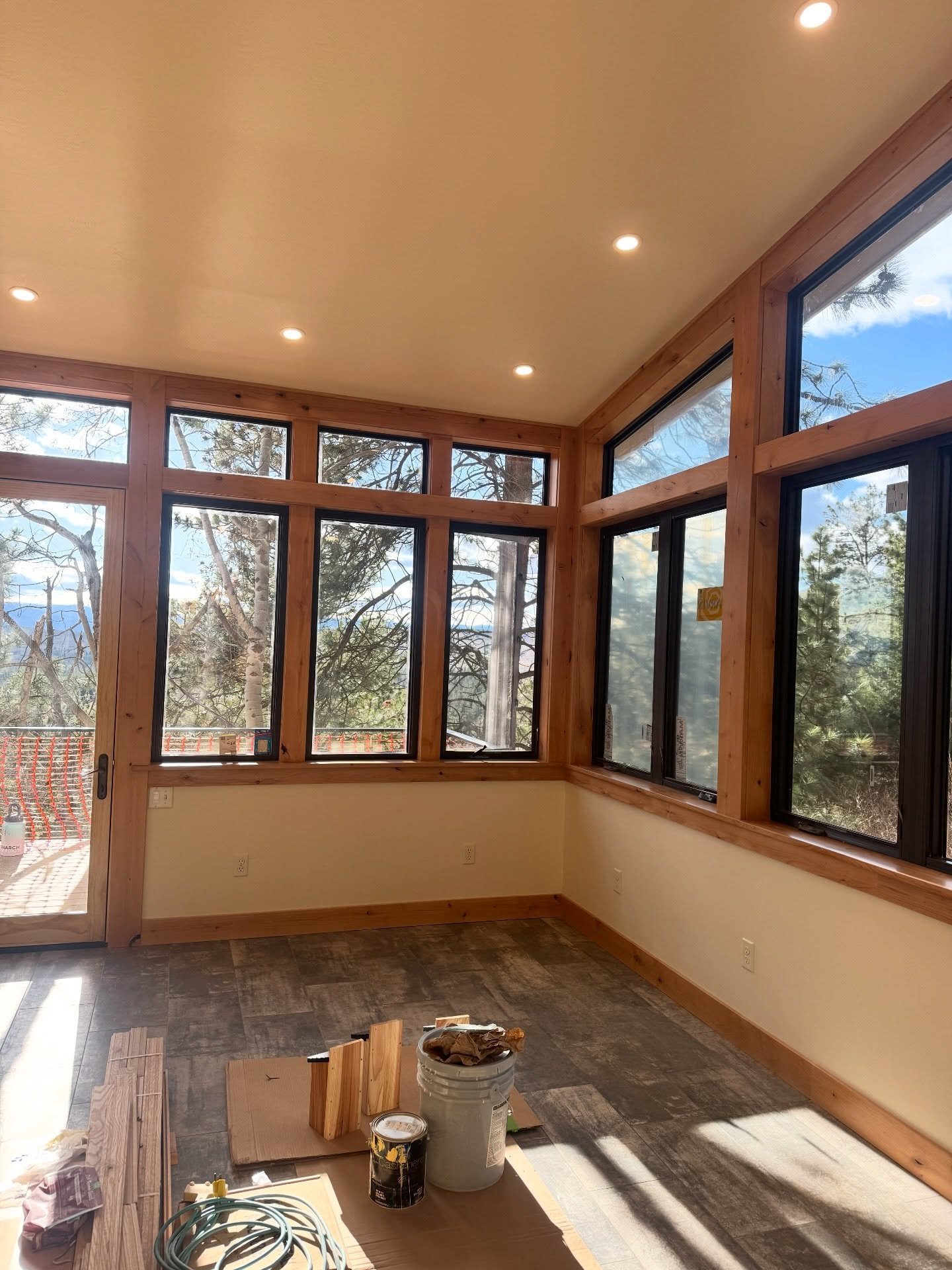 Finished sunroom addition at Elkridge.  This space featured new sheetrock, primed and finished in Navajo White with Sherwin-Williams Cashmere, along with knotty alder trim and doors finished to match.

The trim package required detailed finish work, 