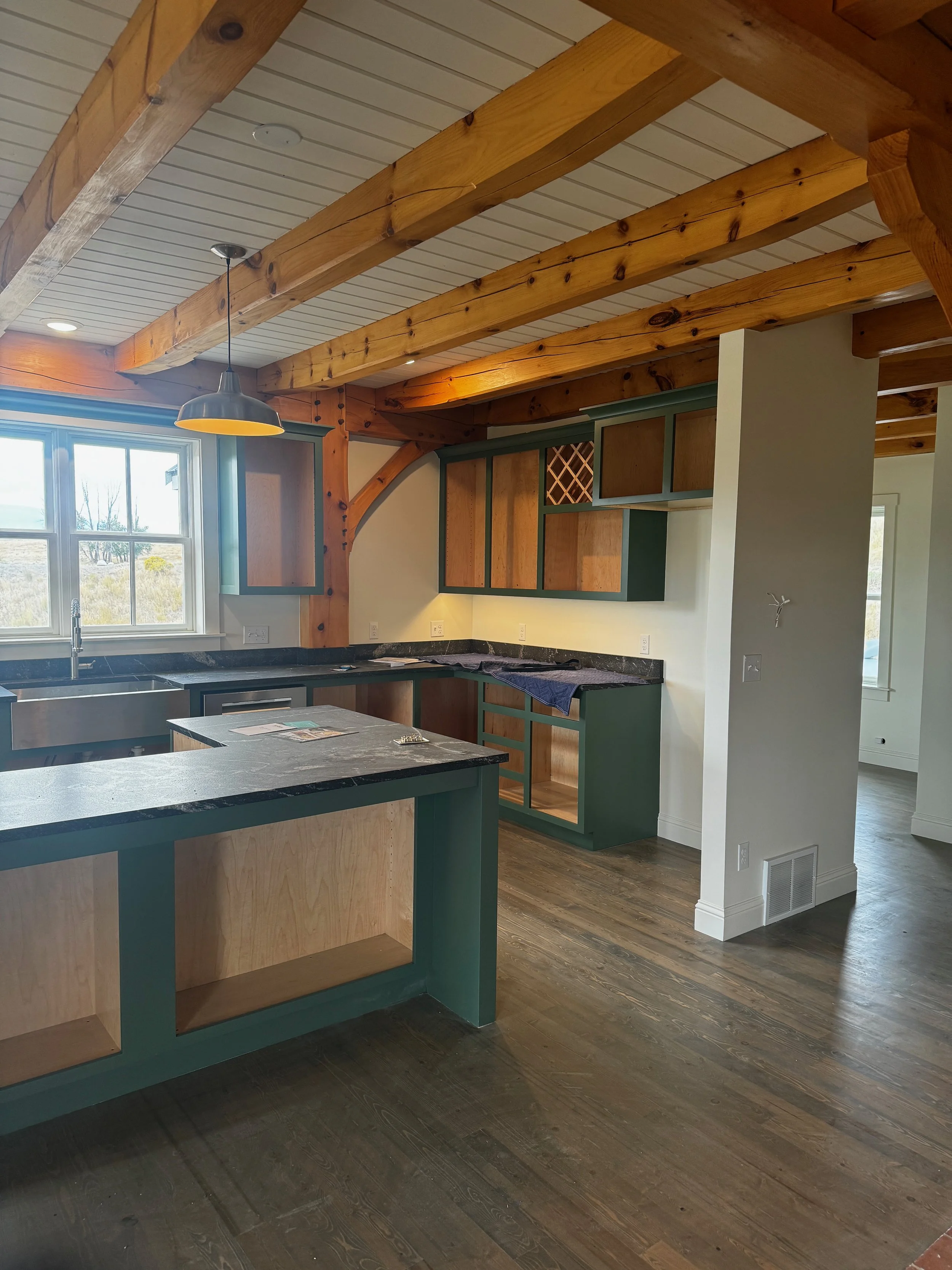 Factory-finish sprayed kitchen cabinets installed on site—cabinet repaint in Missoula, MT.