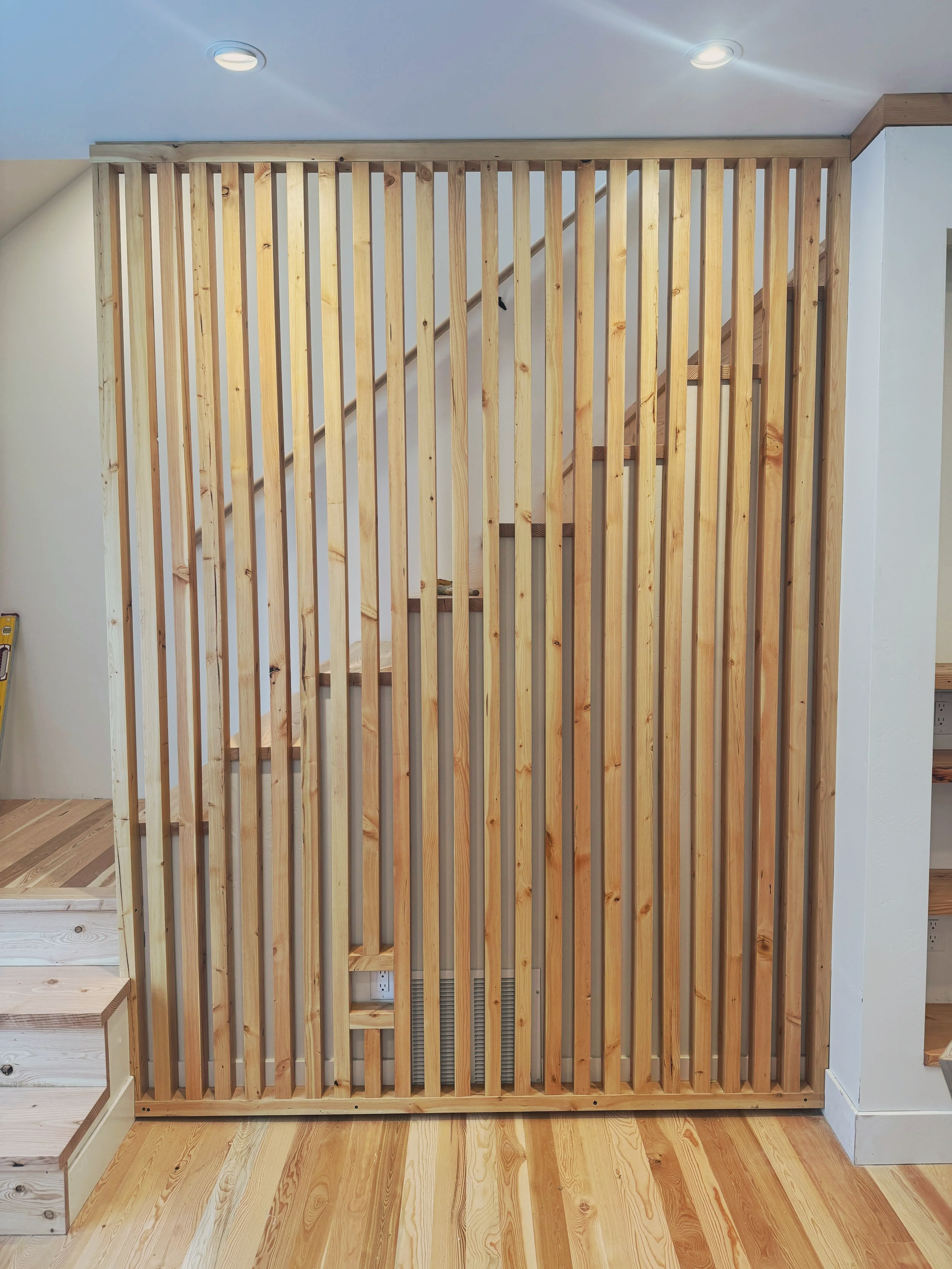 Polyurethane clear coat on a custom screen wall for a Missoula builder — fine-finish woodwork as part of a full interior wood package