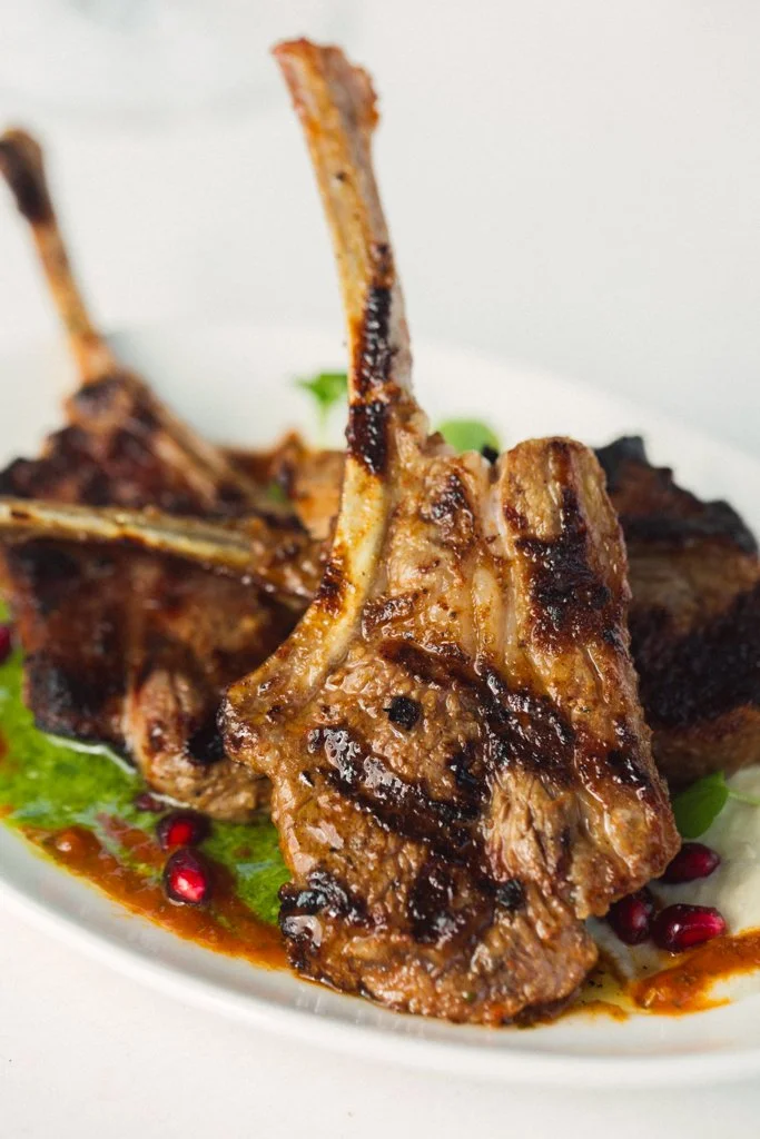 Bbq Lamb Cutlets with lemon potatoes, haloumi, hummus, tzatziki, harissa & Stavros salsa