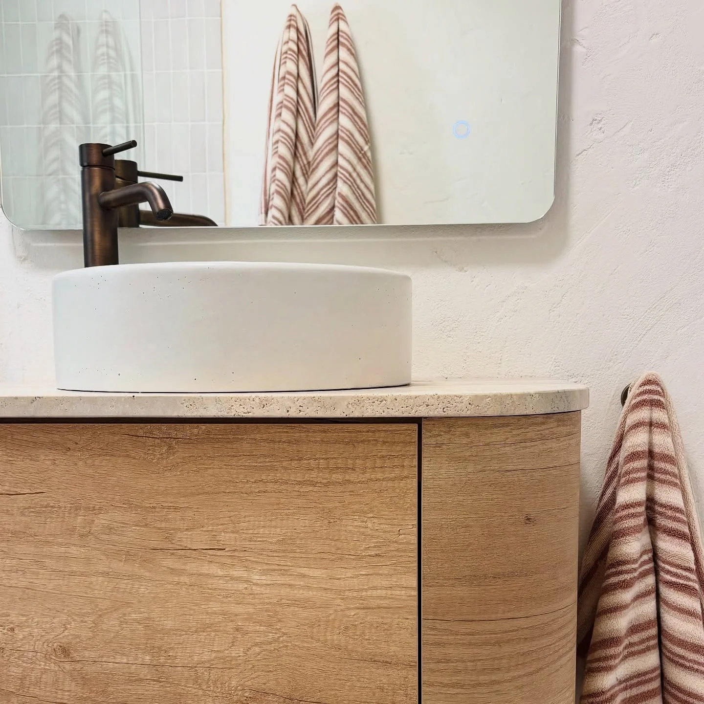 A clean, contemporary finish with timeless materials.

#bathroom #bathroominspo #travertine #concretebasin #antiquebrass #timbervanity