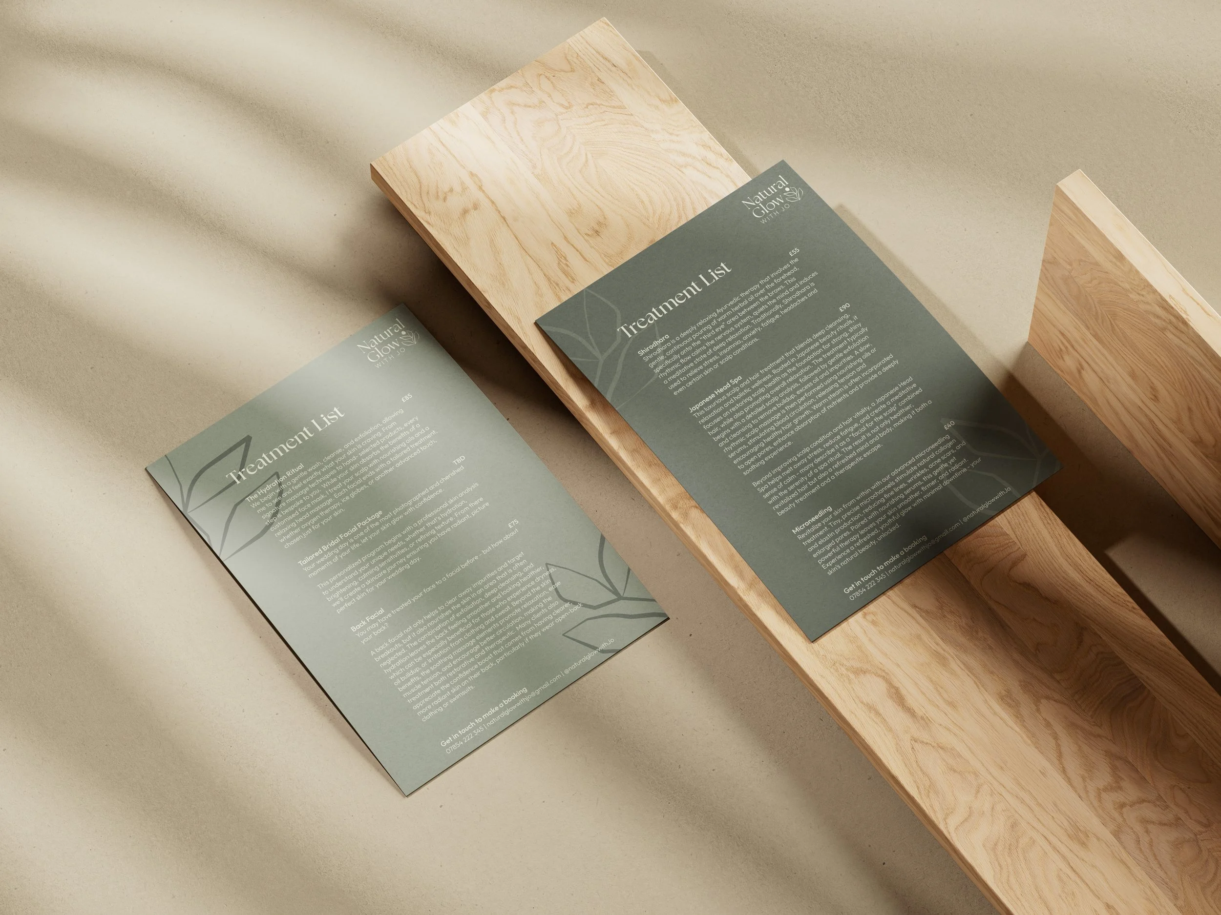 Two printed treatment lists on greenish-gray paper, one placed on a wooden tray, the other on a beige surface, with leaf outlines in the background design.