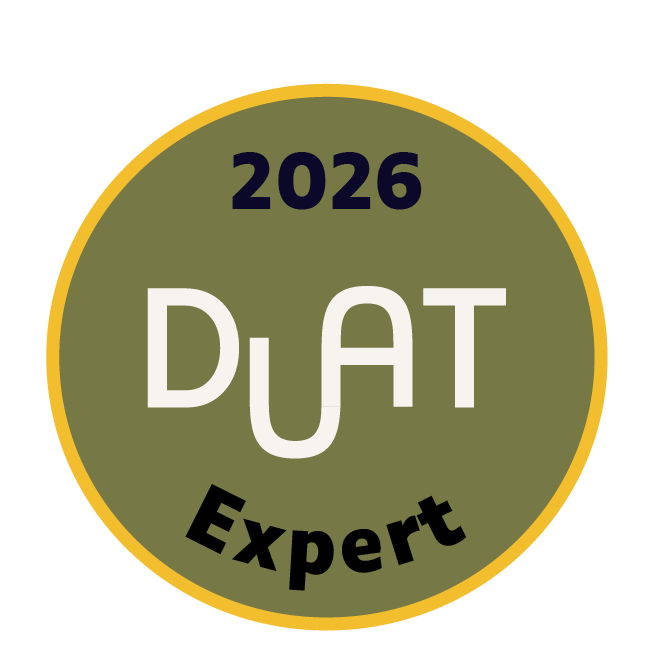 A circular badge with a yellow border, featuring the text "2026 DUA T Expert" in the center on an olive green background.