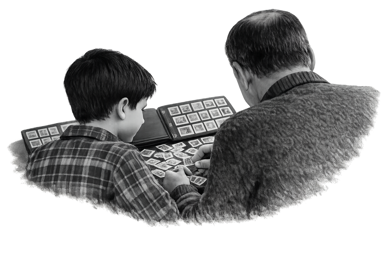 Un enfant et un adulte regardent un album de photos.