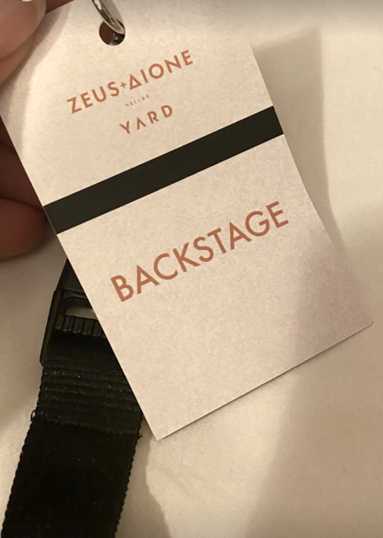 Close-up of backstage pass card on lanyard
