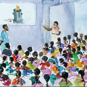 Children sitting on the floor watching a woman who is showing them a picture of the Anila biochar stove in a classroom.