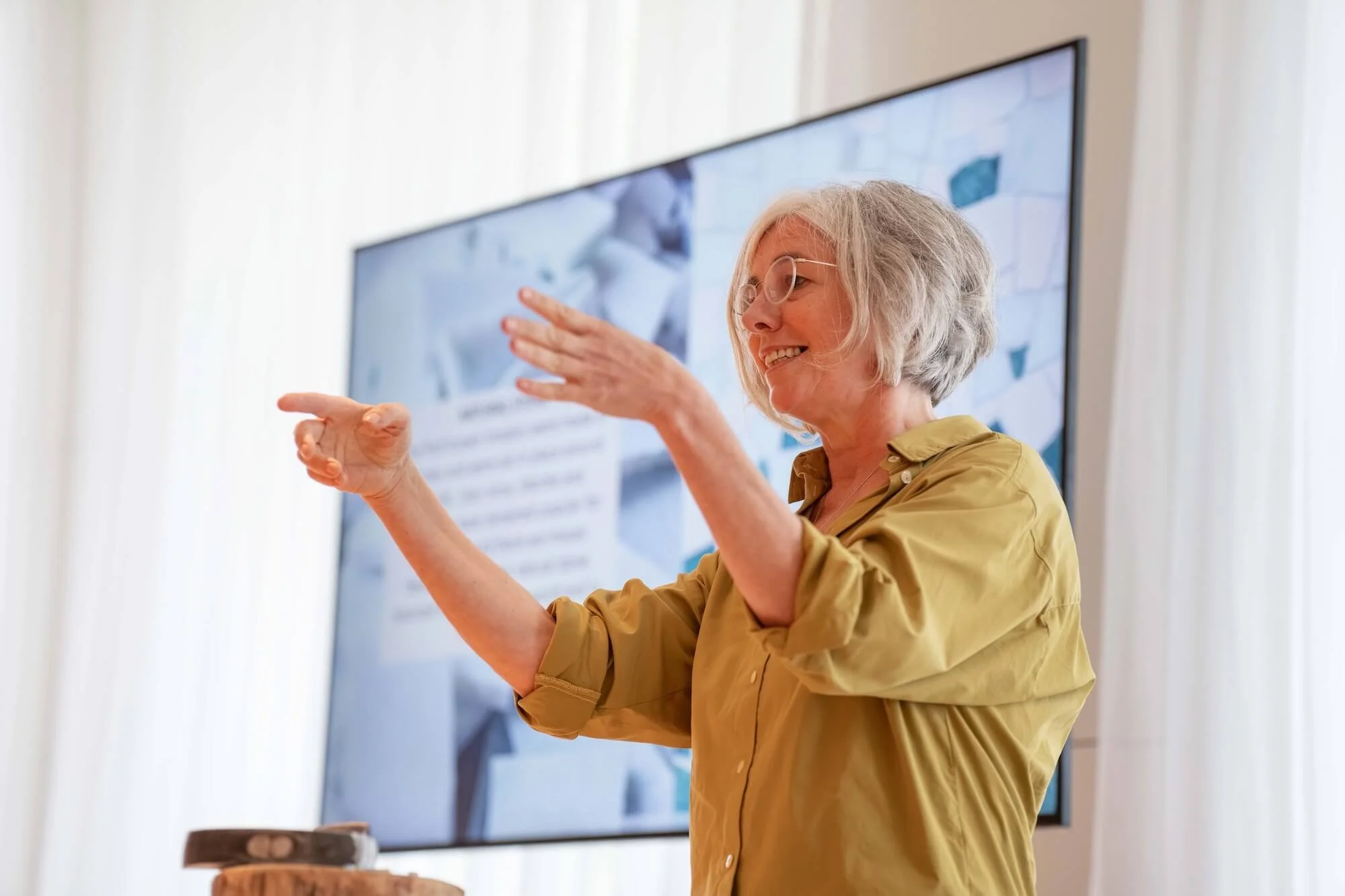 Teichert standing in front of audience with hands raised