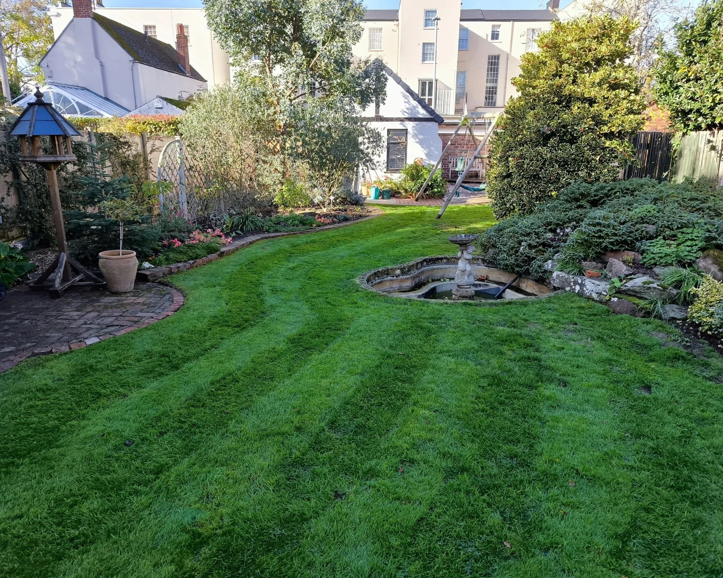 Inspiring image of garden maintenance with a lawn mower on grass lawn. Highlighting professional mowing techniques and a beautifully maintained lush and healthy lawn.
