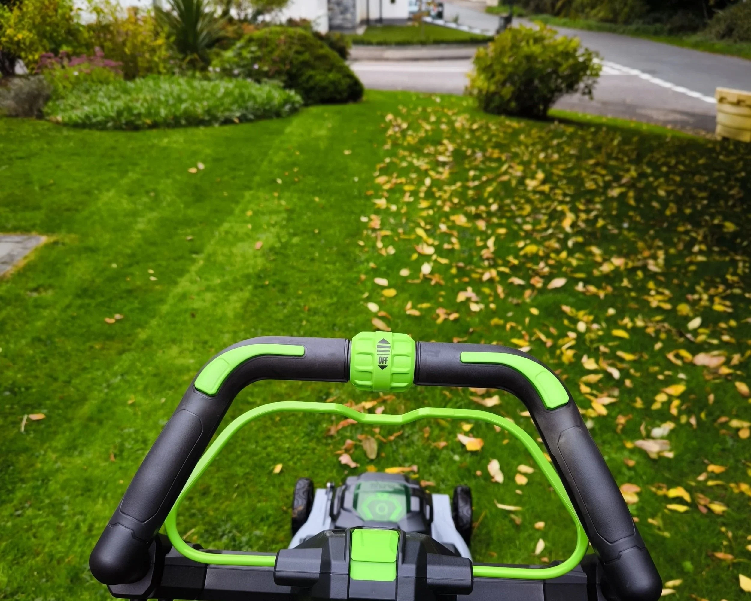 Gardener mowing and maintaining a garden.