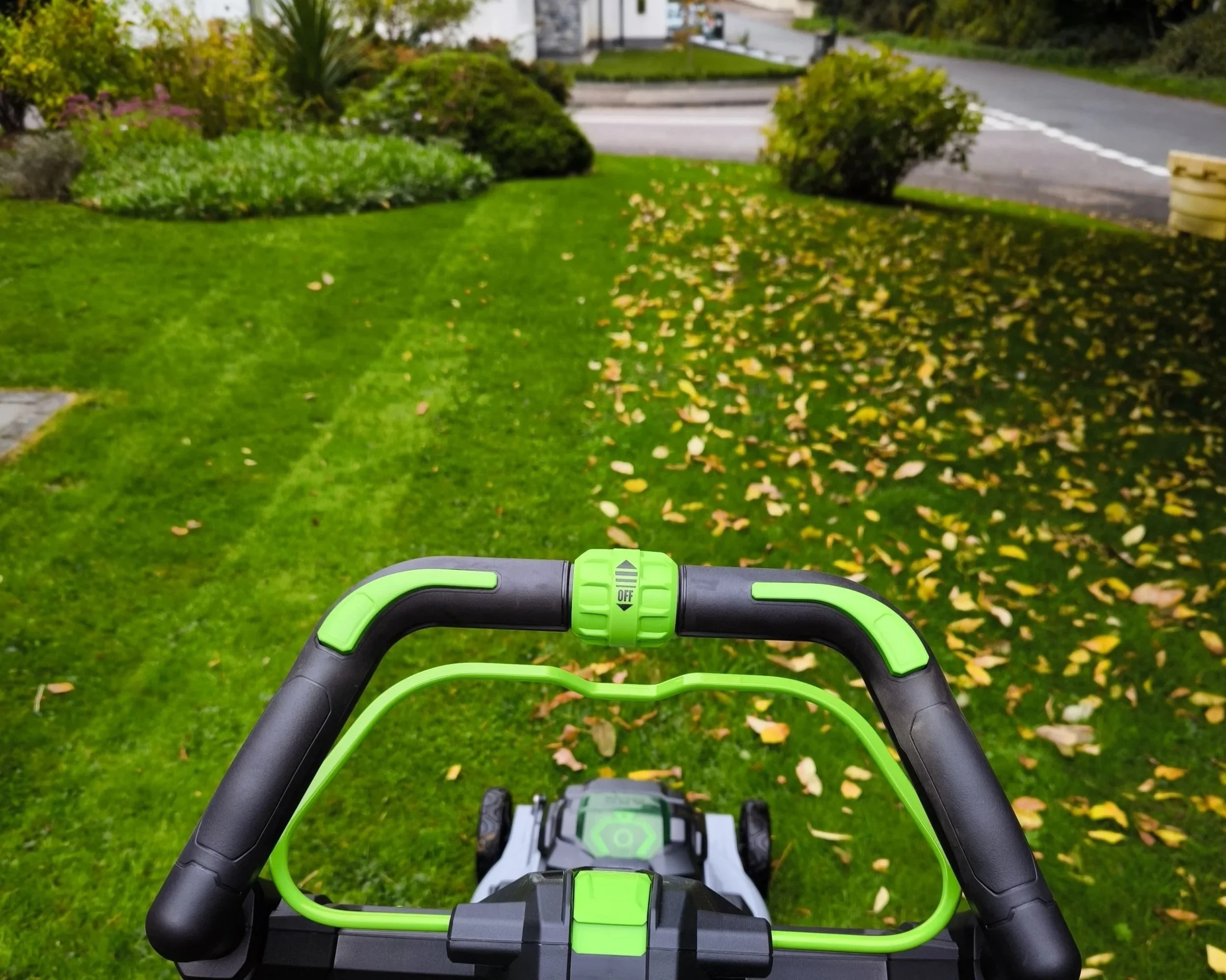 Garden maintenance with a lawn mower on grass lawn