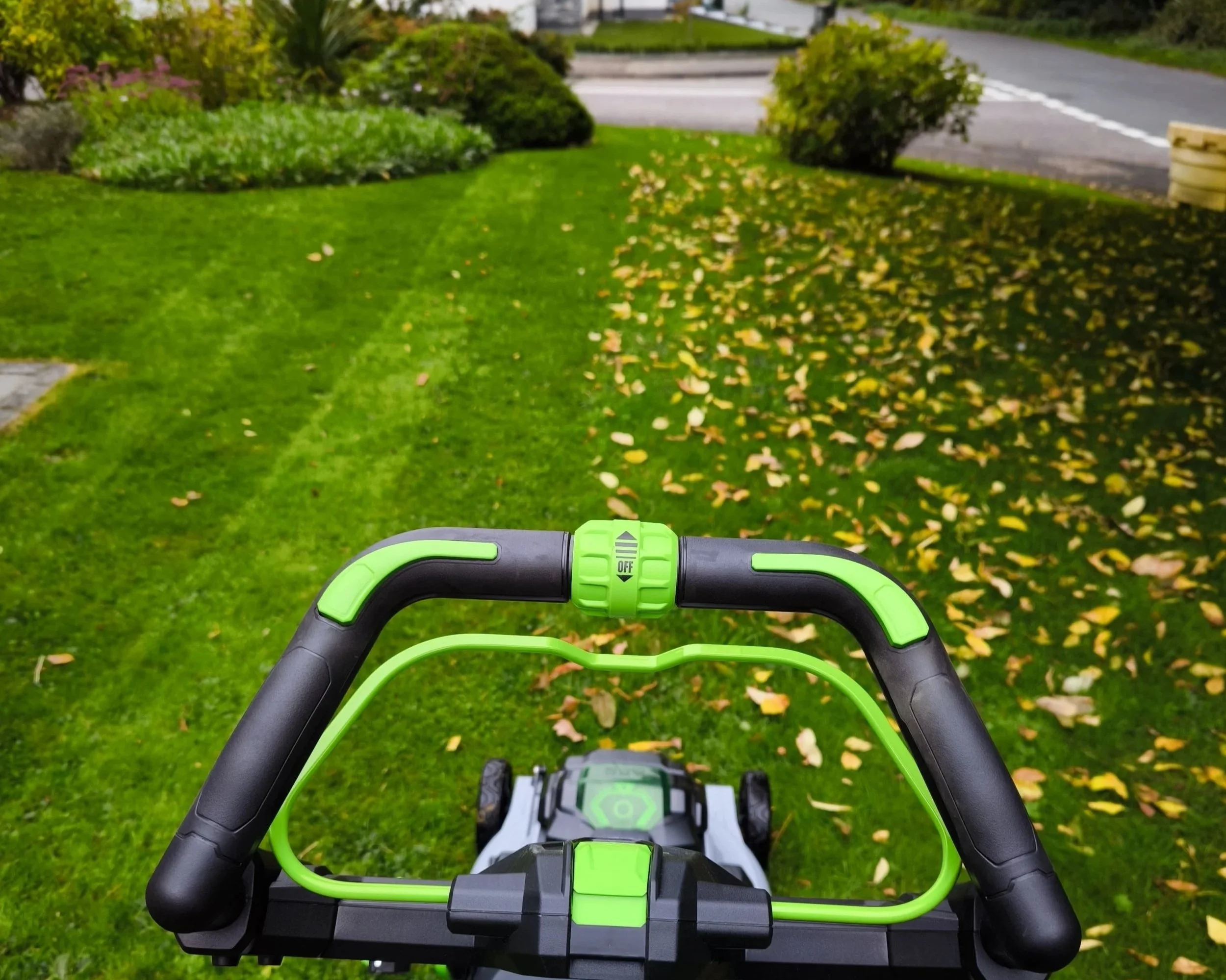 Garden maintenance with a lawn mower on grass lawn.