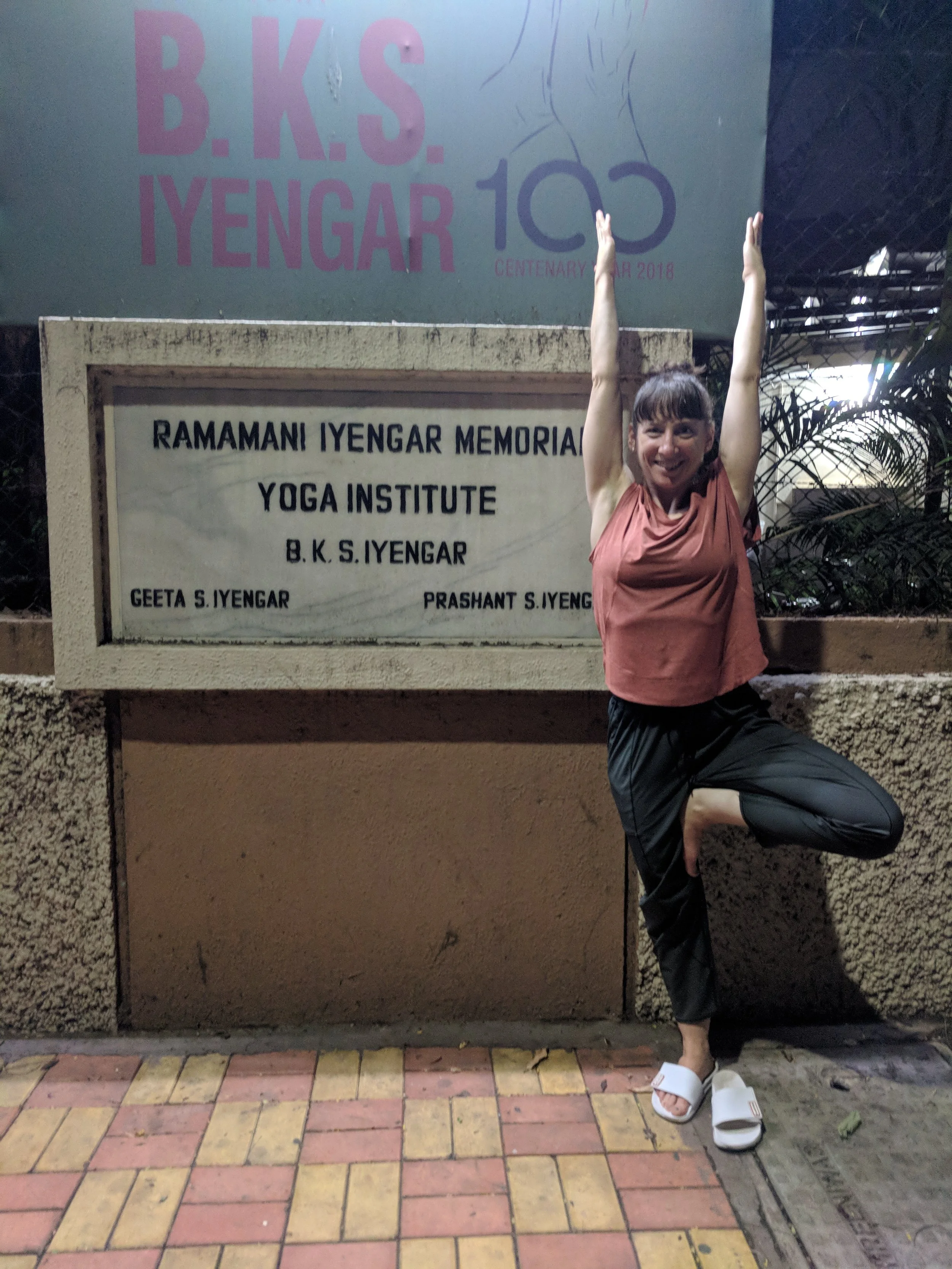 Certified Iyengar Yoga Teacher Stephanie Tencer performing Vrksasana (Tree Pose) at the Ramamani Iyengar Memorial Yoga Institute in Pune, India.