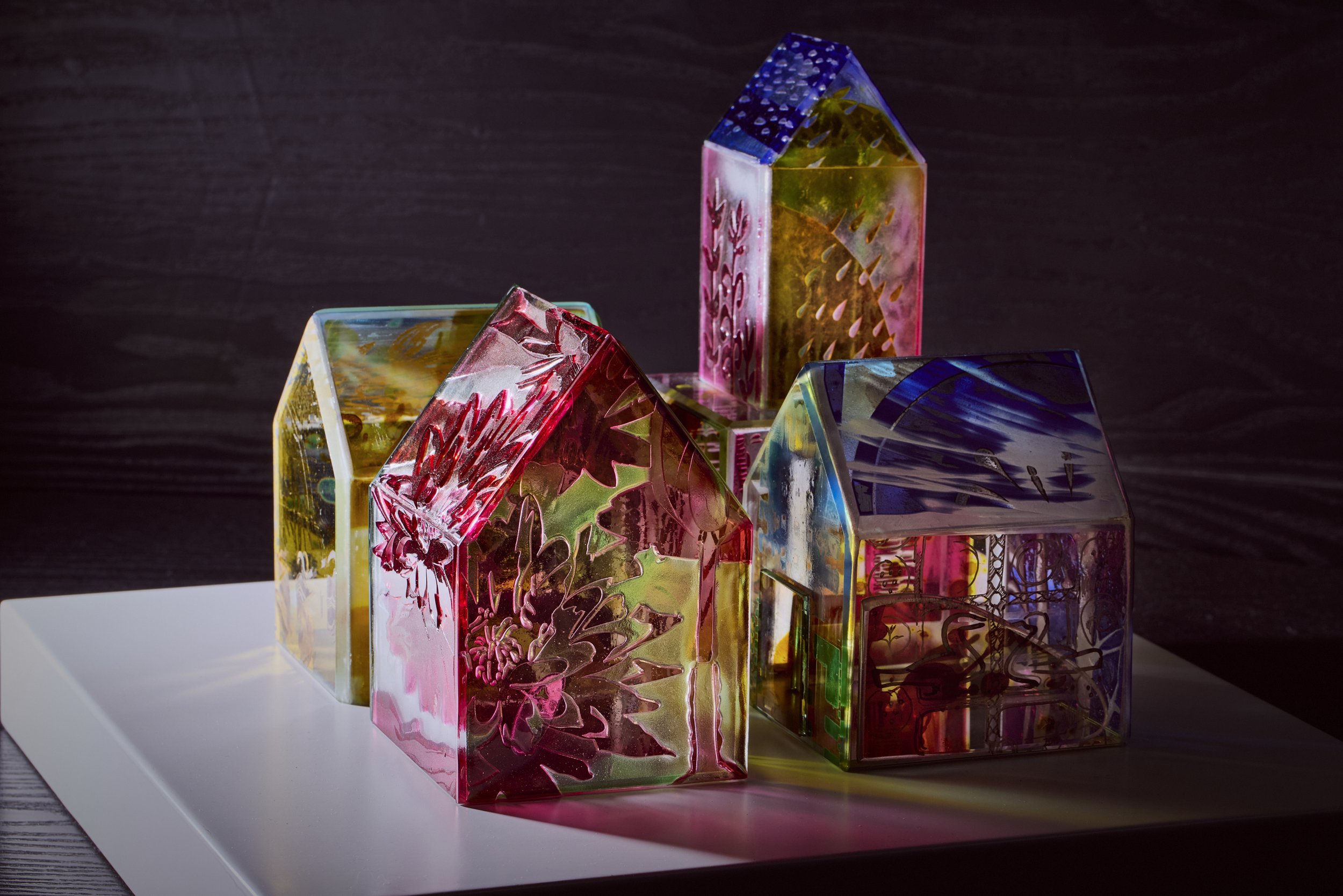 RACHEL PHILLIPS' Indwelling: Painted Houses. Stained glass constructions on white plinth at Mandarin Oriental Mayfair. QEST