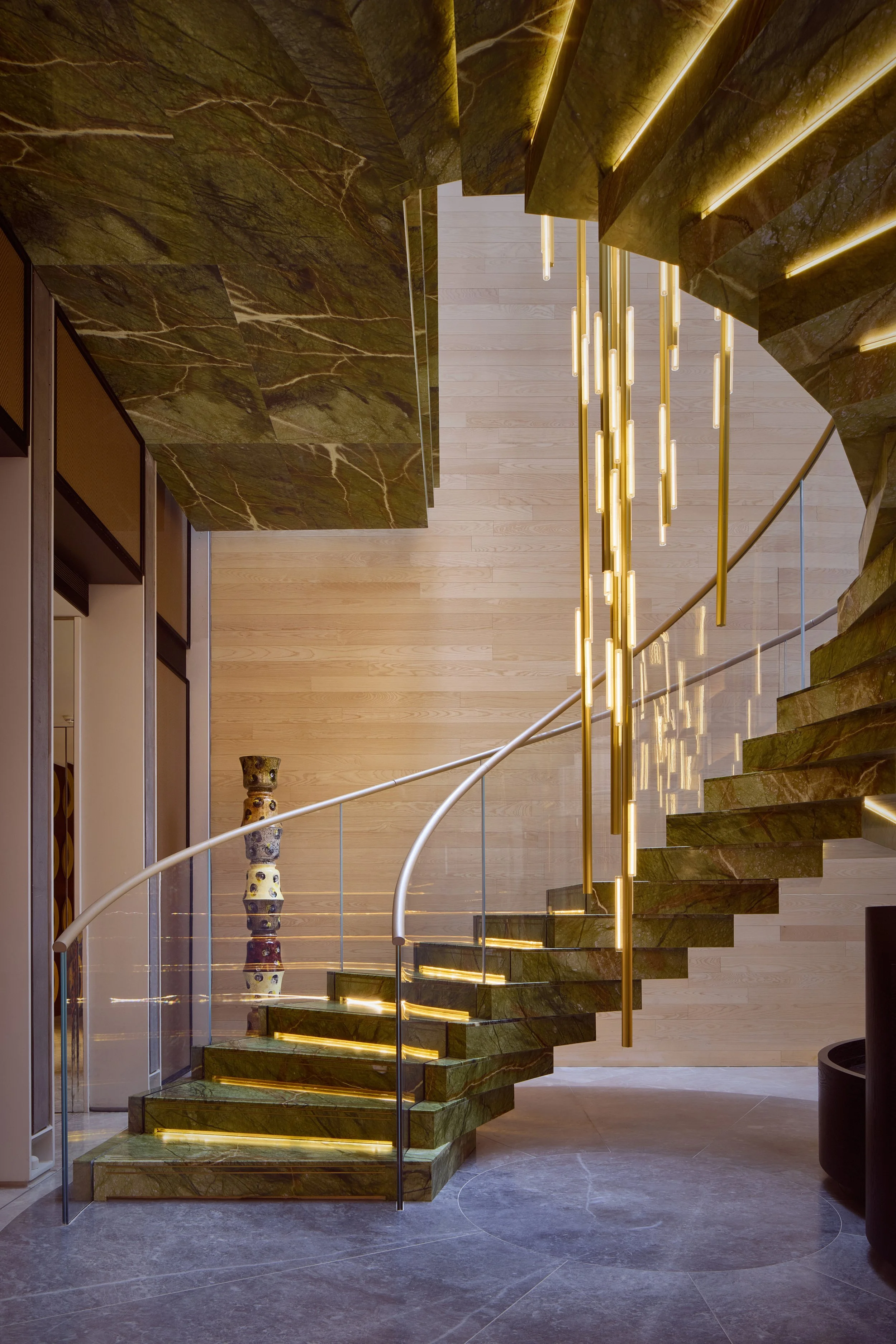 Mandarin Oriental Mayfair Atrium stairwell in green marble with 1882 Ltd Martyn Thompson Ceramic Column #2 and Lee Broom Hail Chandelier