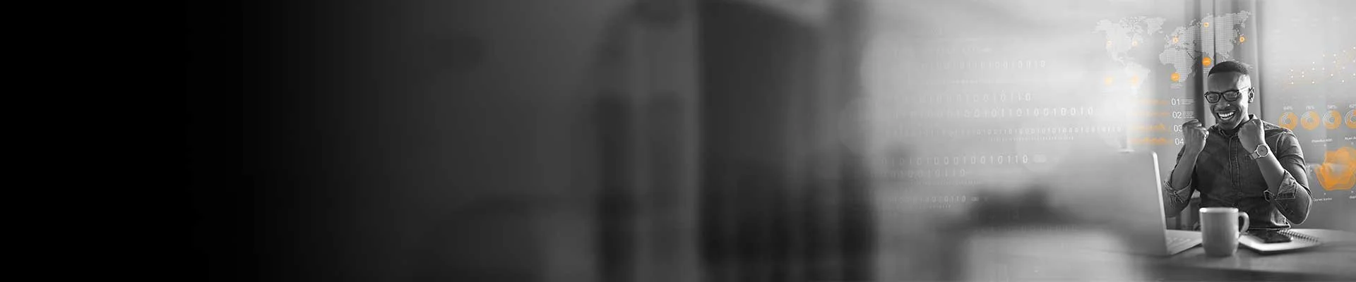 A woman sitting at her desk in front of a laptop, celebrating with clenched fists and a big smile, in a modern office with digital graphics on the wall.