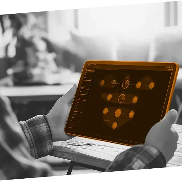 Person holding a tablet displaying a football team's formation diagram.