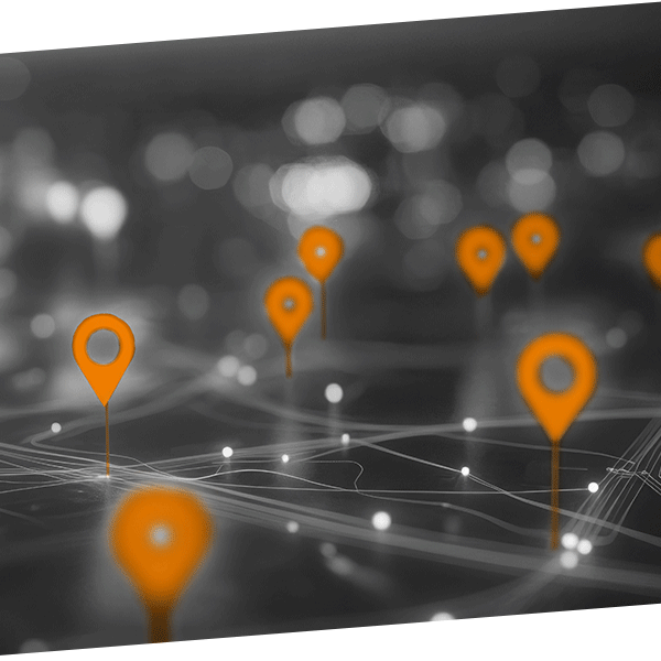 Digital map with orange location pins and interconnected lines on a dark background.