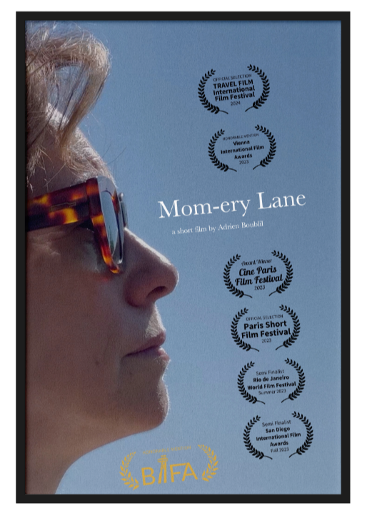 Close-up side profile of a woman wearing sunglasses, with film festival award laurels and title 'Mom-ery Lane' over a light blue background.