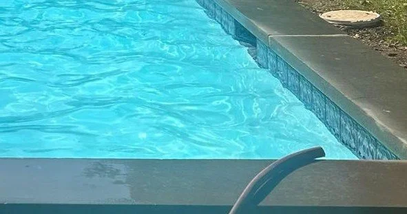 Bright inground pool after professional acid washing to remove stains and discoloration.