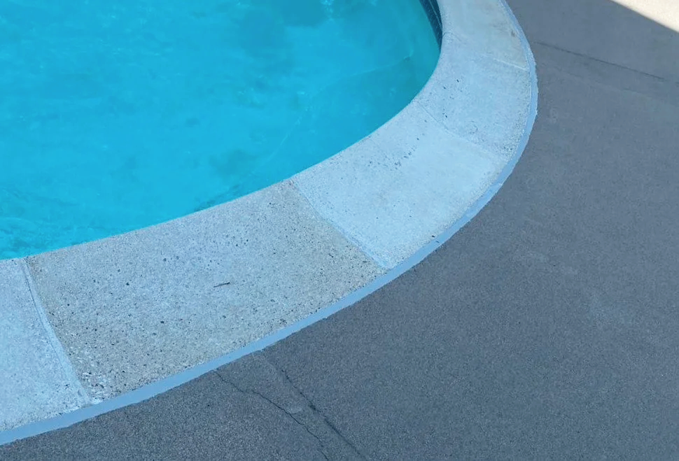 Restored pool deck with fresh Deck-O-Seal coating to protect and give a clean, finished look.