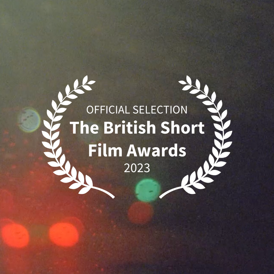 Award logo for the 2023 British Short Film Awards with a dark background and light bokeh effects.