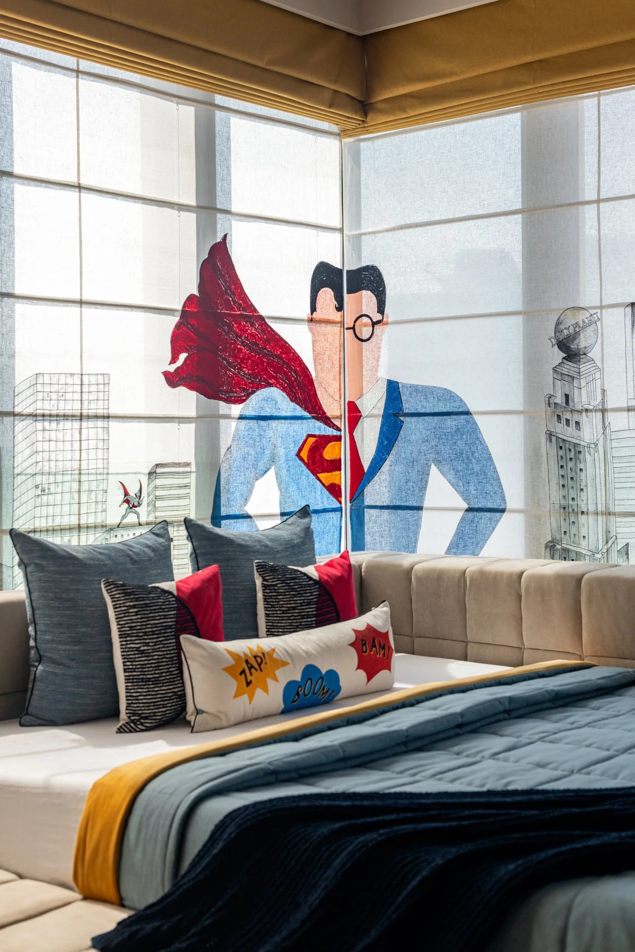 A drawn mural of a superhero resembling Superman with a red cape and glasses, depicted on a large window in a living room area.