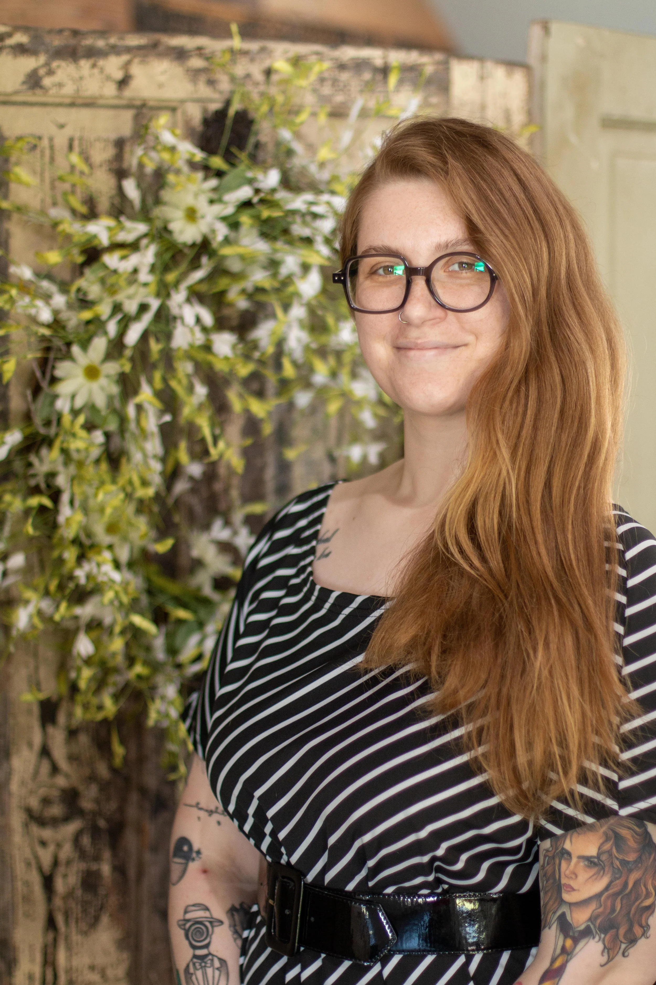 Woman with glasses, standing, soft smile