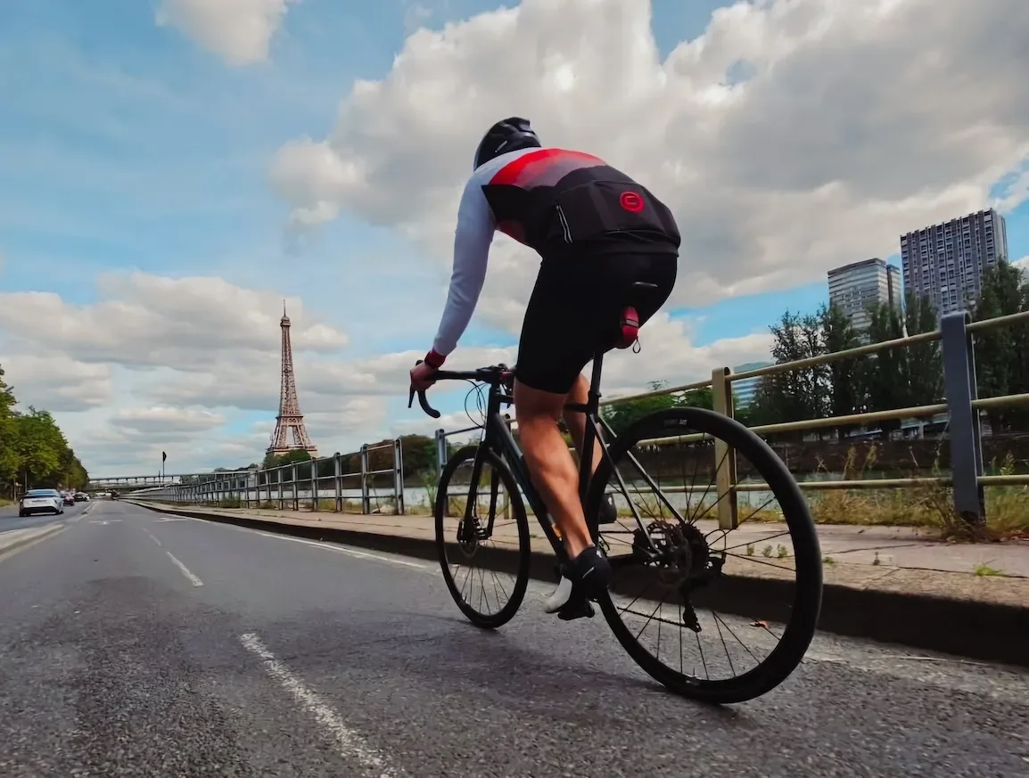 Cyclist in Paris with the Eiffel Tower in the background