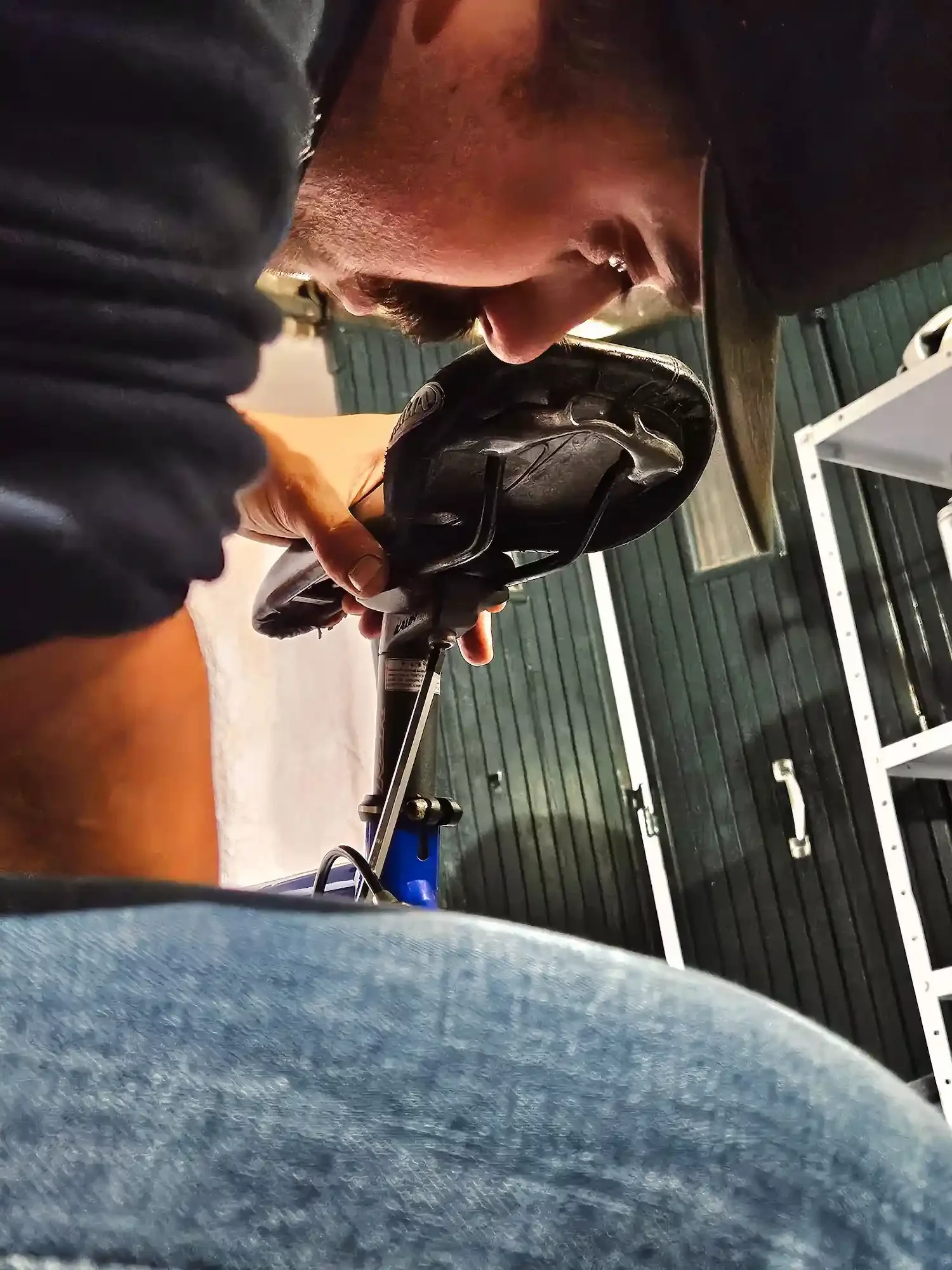 Bike mechanic adjusting saddle height.