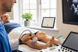 Medical professional performing an ultrasound on a patient's arm in a hospital room