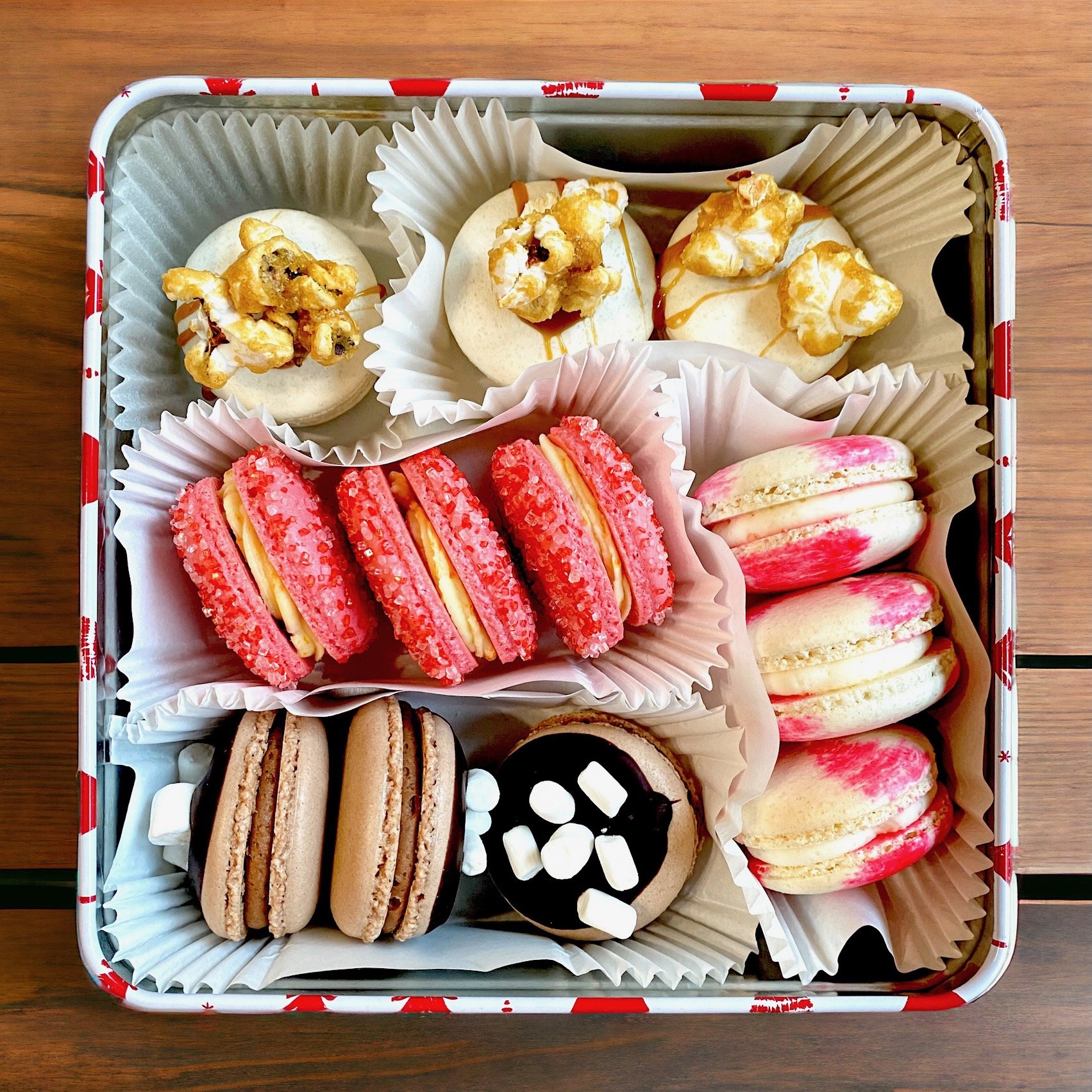 12 macaron cookies arranged in a gift tin for holidays