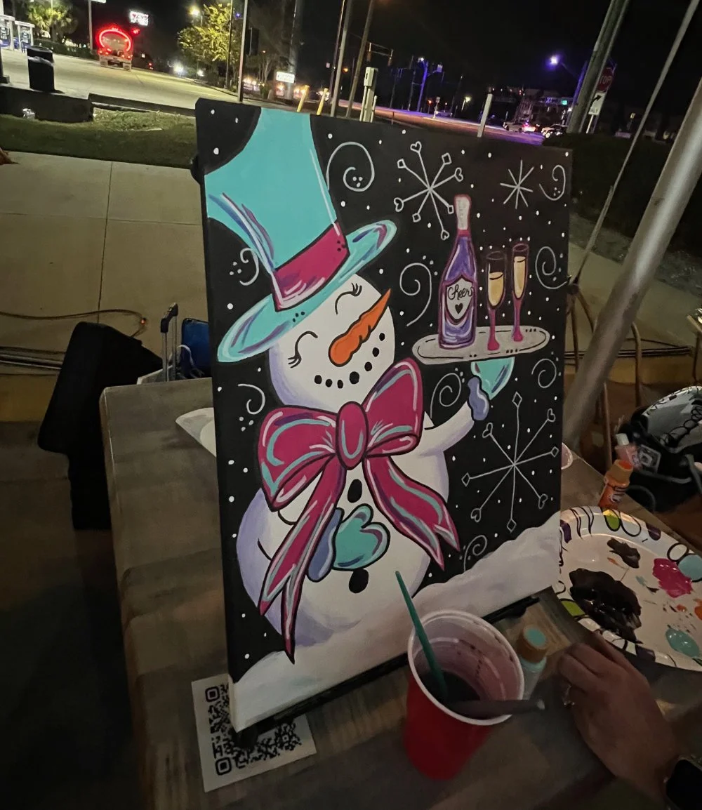 Colorful artwork of a snowman with a red bowtie and purple top hat, holding a tray with a purple bottle labeled 'Cheers' and two glasses. Snowflakes and swirly lines decorate the background, which is black.