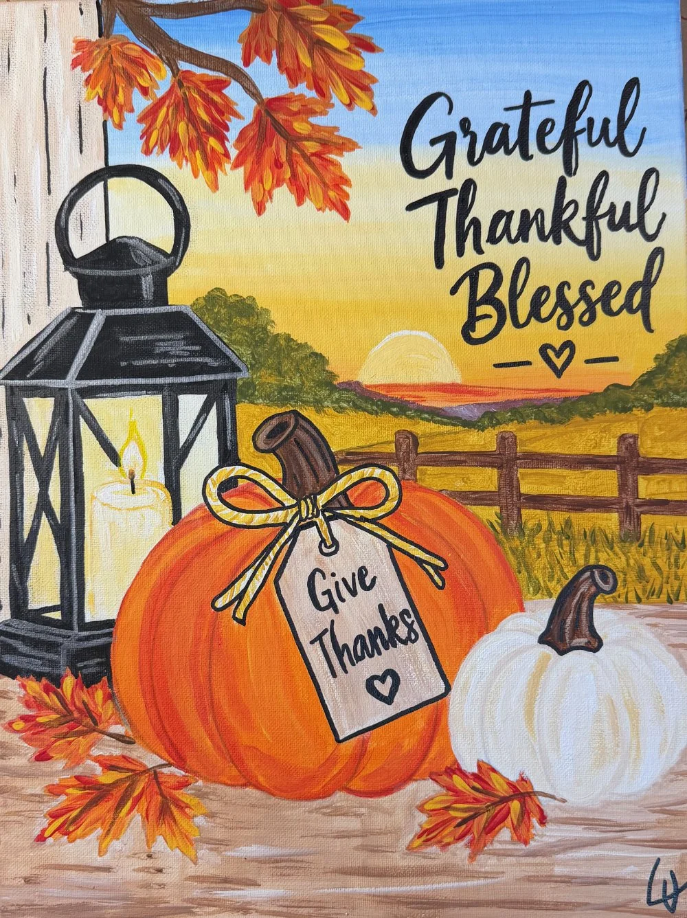 An autumn scene with a sunset in the background, featuring two pumpkins, a lantern with a lit candle, and fall leaves. The larger pumpkin has a tag that says 'Give Thanks' and the background includes a wooden fence and fields. The text on the image says 'Grateful, Thankful, Blessed'.