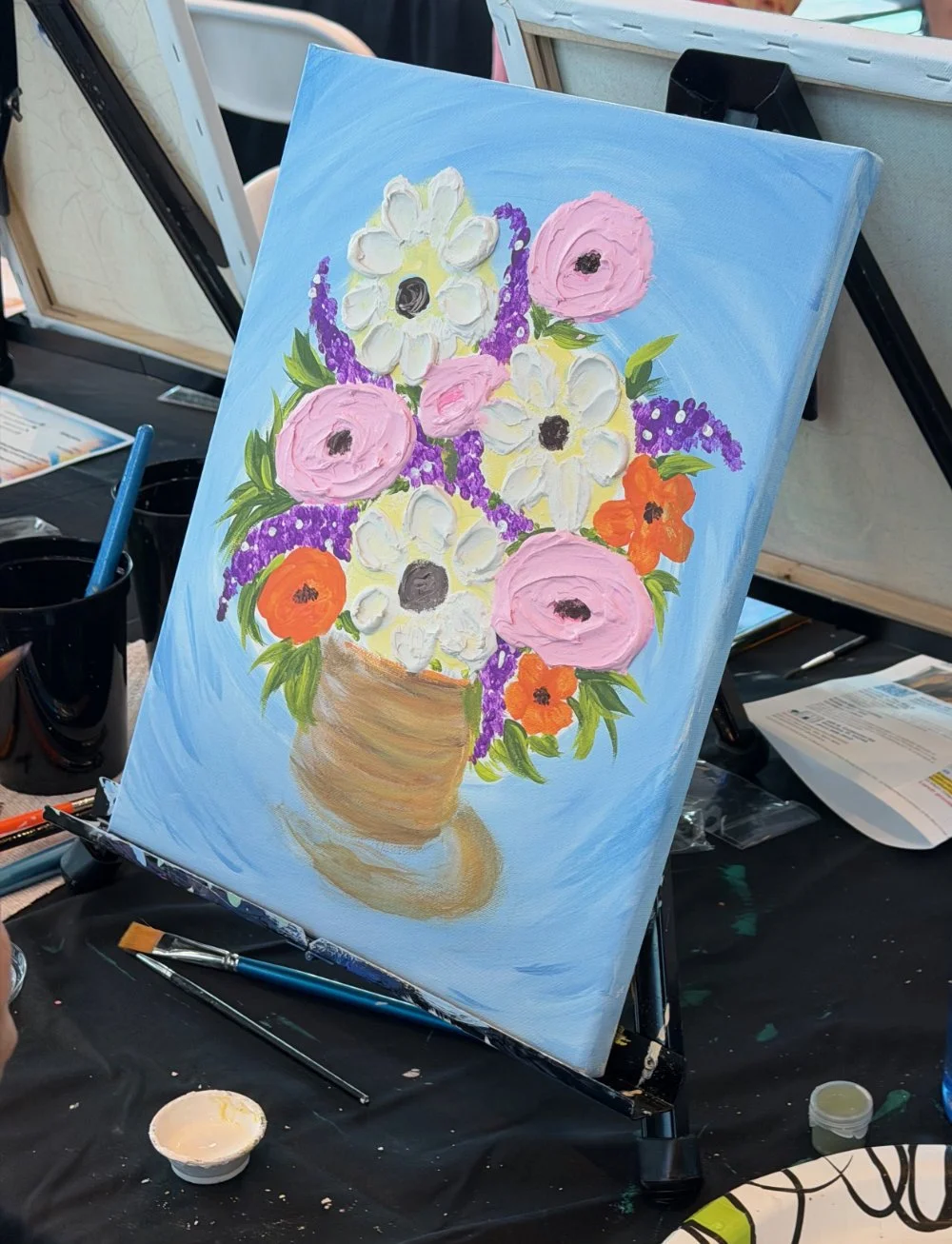 A painting of a bouquet of flowers in a brown vase, featuring pink, white, orange, and purple flowers on a blue background.