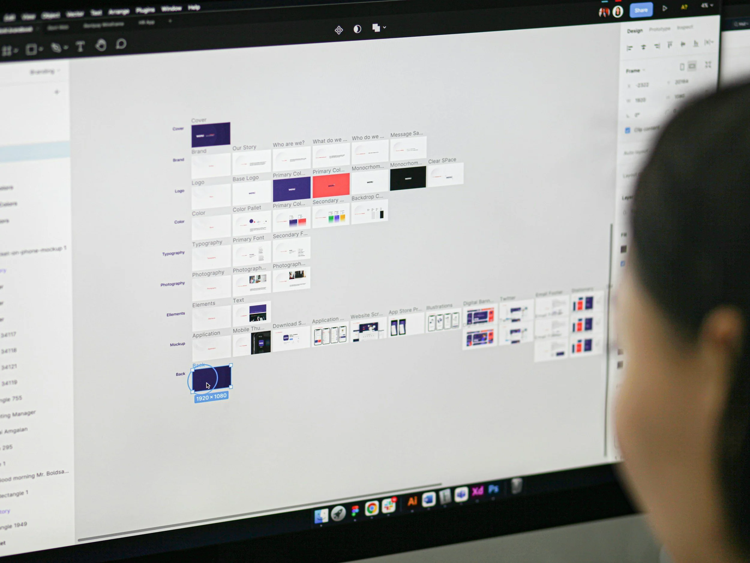 Person viewing a computer screen displaying a digital design software interface with many thumbnails of project files and a workspace.