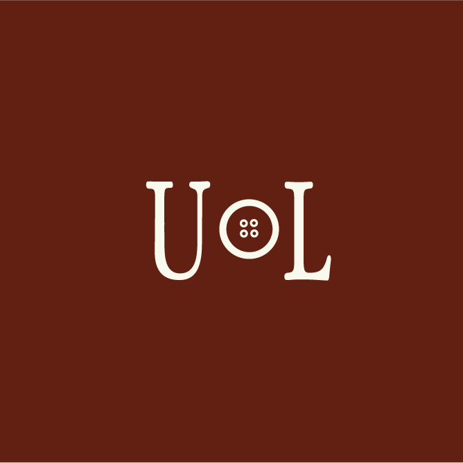 Brown background with the word 'TON' upside down, with the letter 'O' replaced by a button with four holes.