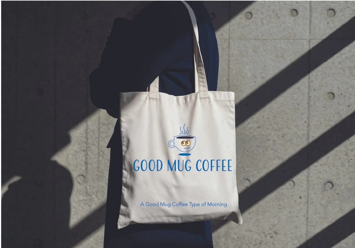 Branded tote bag mockup displaying the Good Mug Coffee logo and tagline on a white canvas bag.