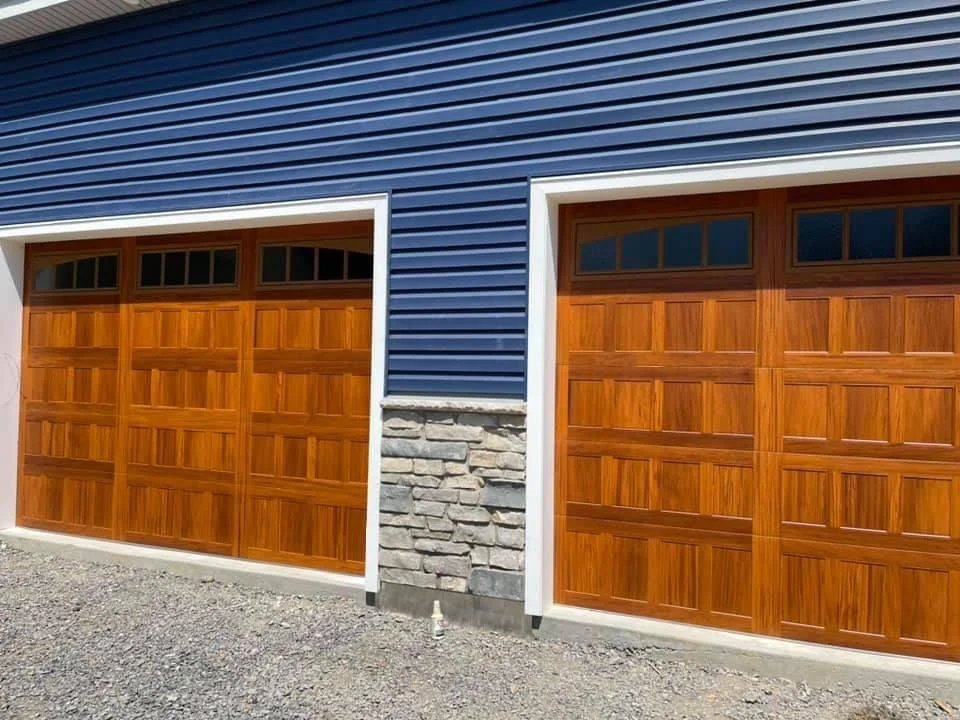 Two Wooden Stamped Shaker Garage Door on Blue House