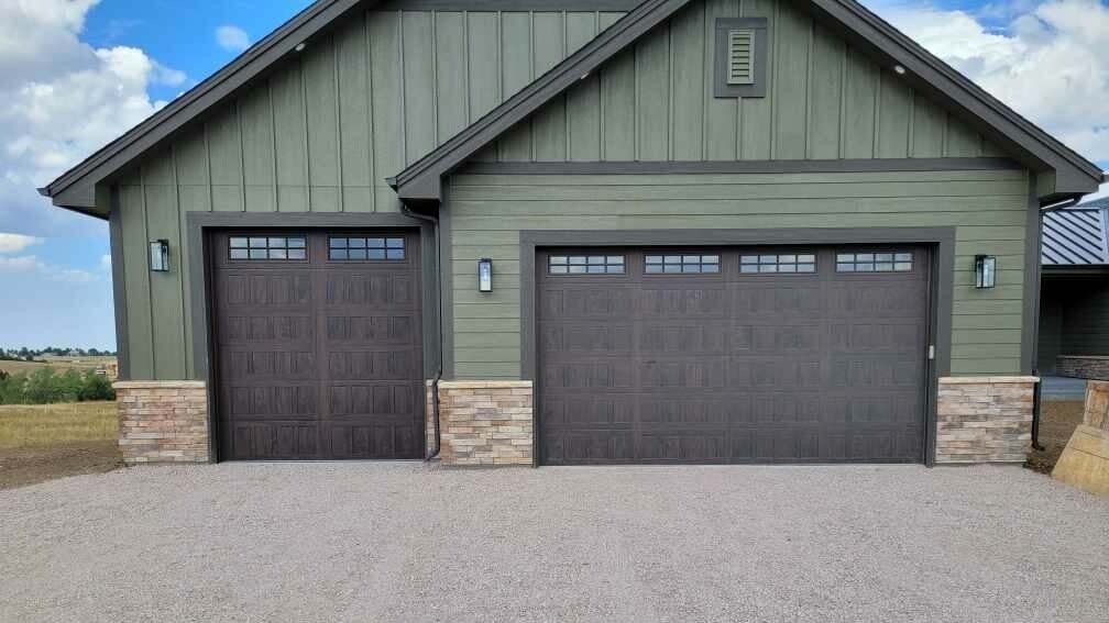 Two Wooden Stamped Shaker Garage Doors on Green House